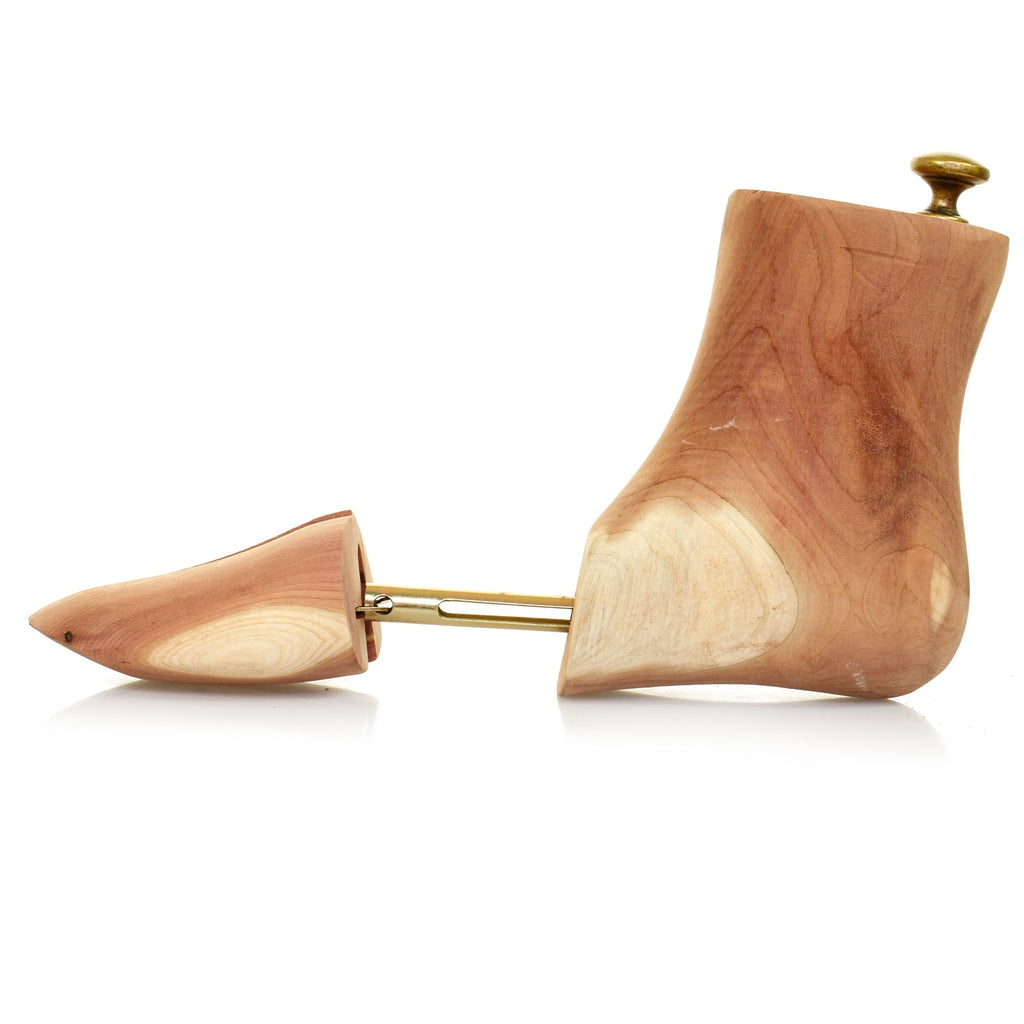 Single cedar wood shoe tree, expanded to show adjustable spring mechanism for shoe care.