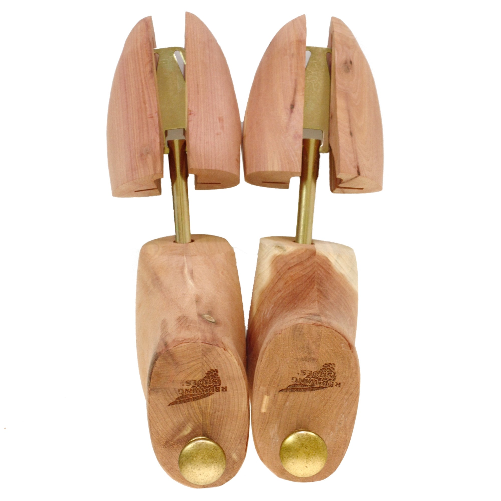 Top-down view of a pair of cedar shoe trees, highlighting the split toe design and brass details.