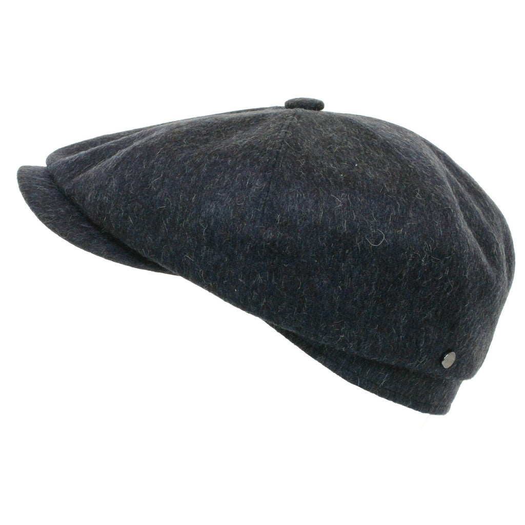 Dark grey herringbone flat cap from the side, showing a decorative button.