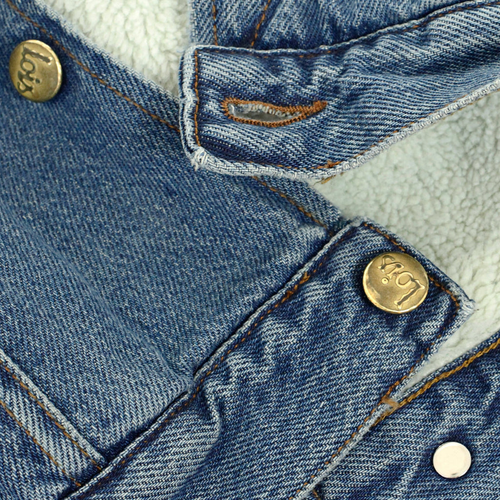 A close-up of the jacket's button and fleece lining, showcasing the texture.