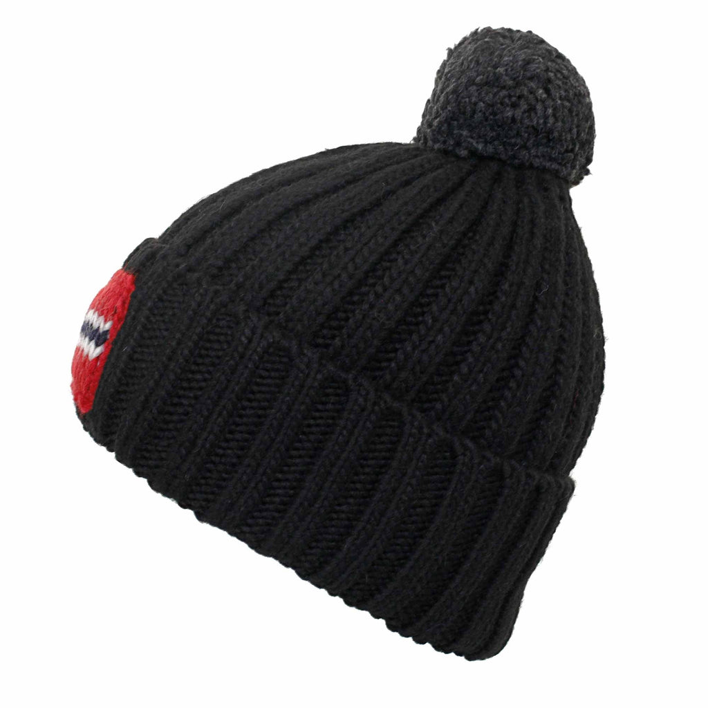 A black knitted bobble hat featuring a Norwegian flag patch, shown from a side angle.