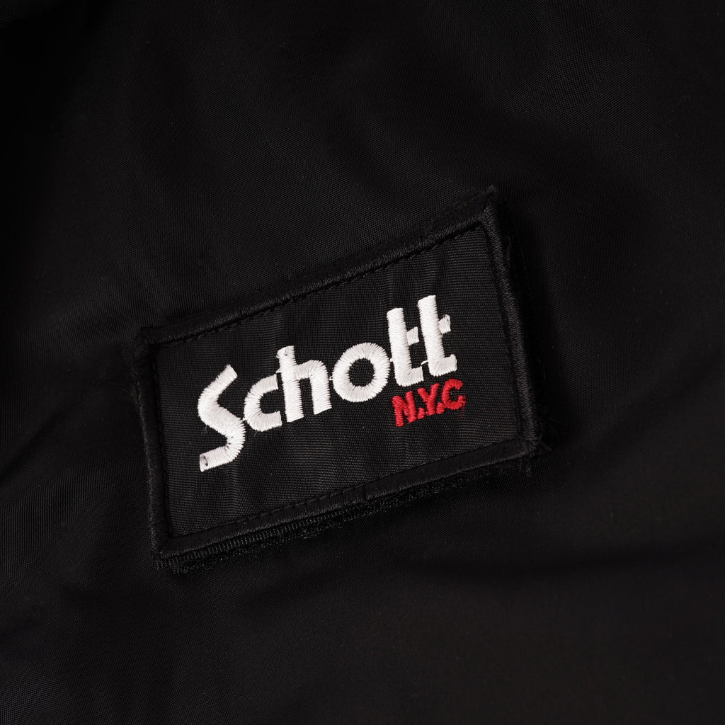 A close-up of the 'Schott N.Y.C' logo patch on a black jacket.