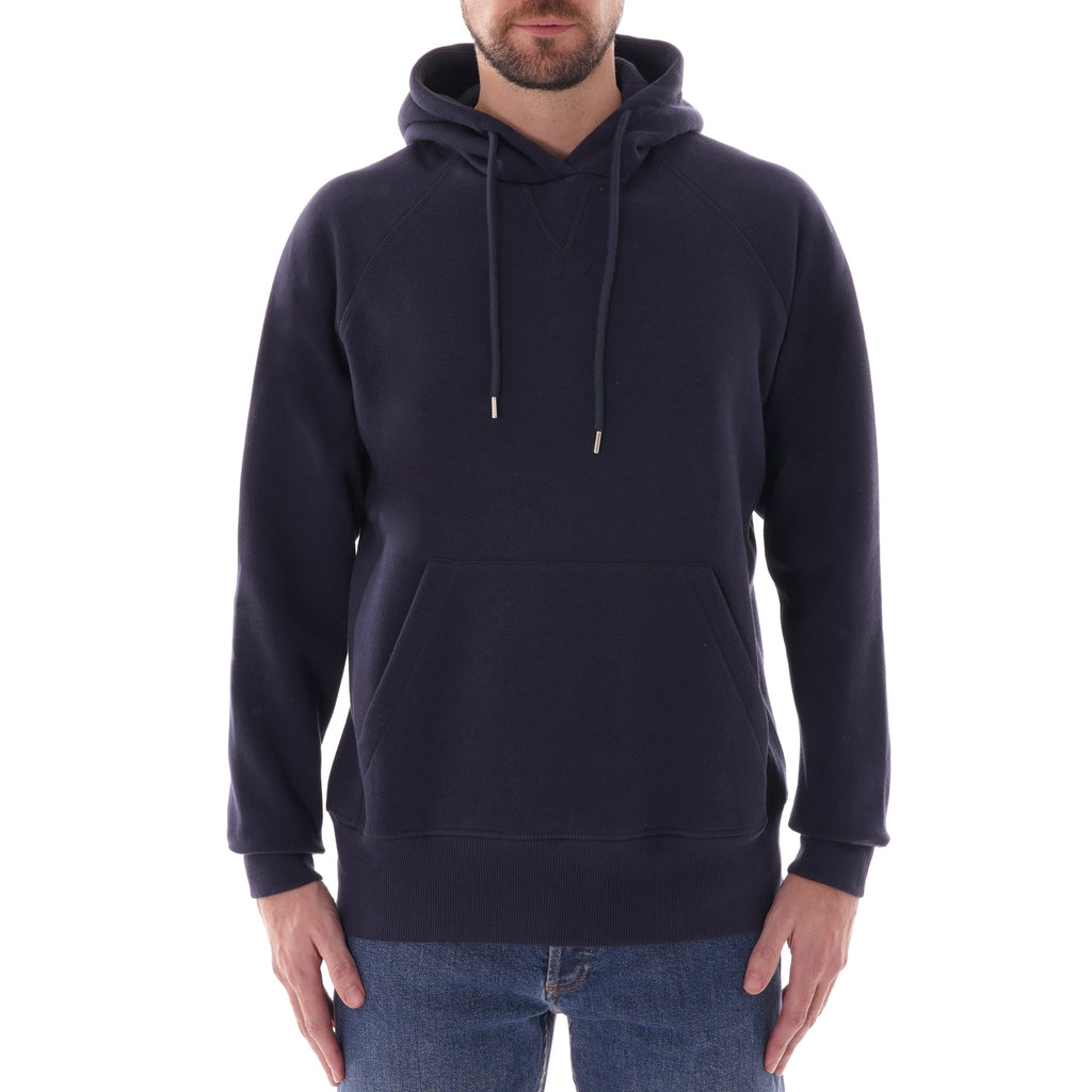 A man models a C17 Jeans raglan sleeve hoodie in navy.