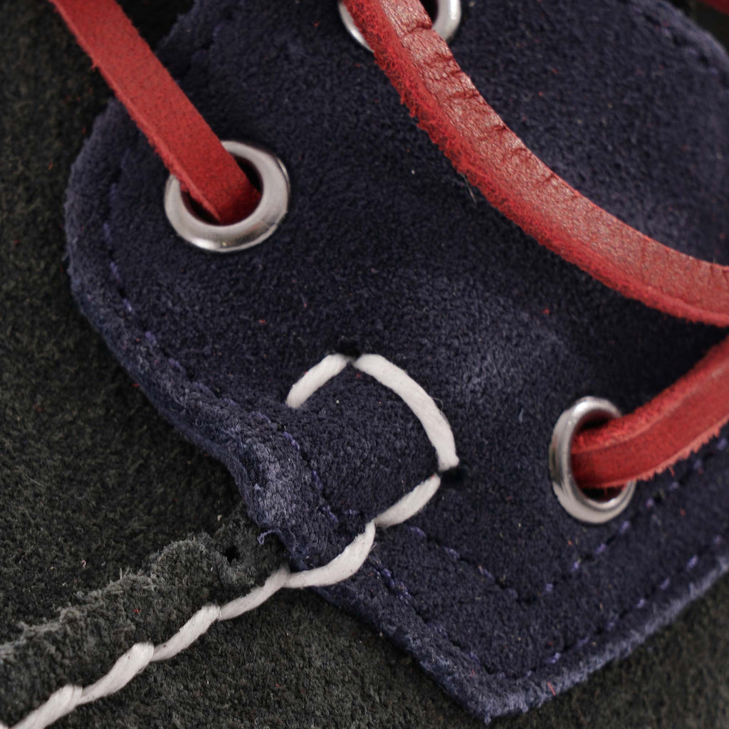 Close-up of the red laces through eyelets on a Sebago Baracuta Portland boat shoe.