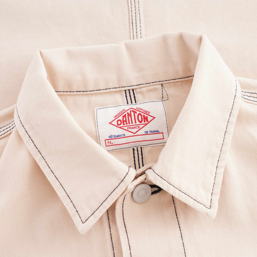 Close-up of the collar and Danton brand label on a beige jacket.