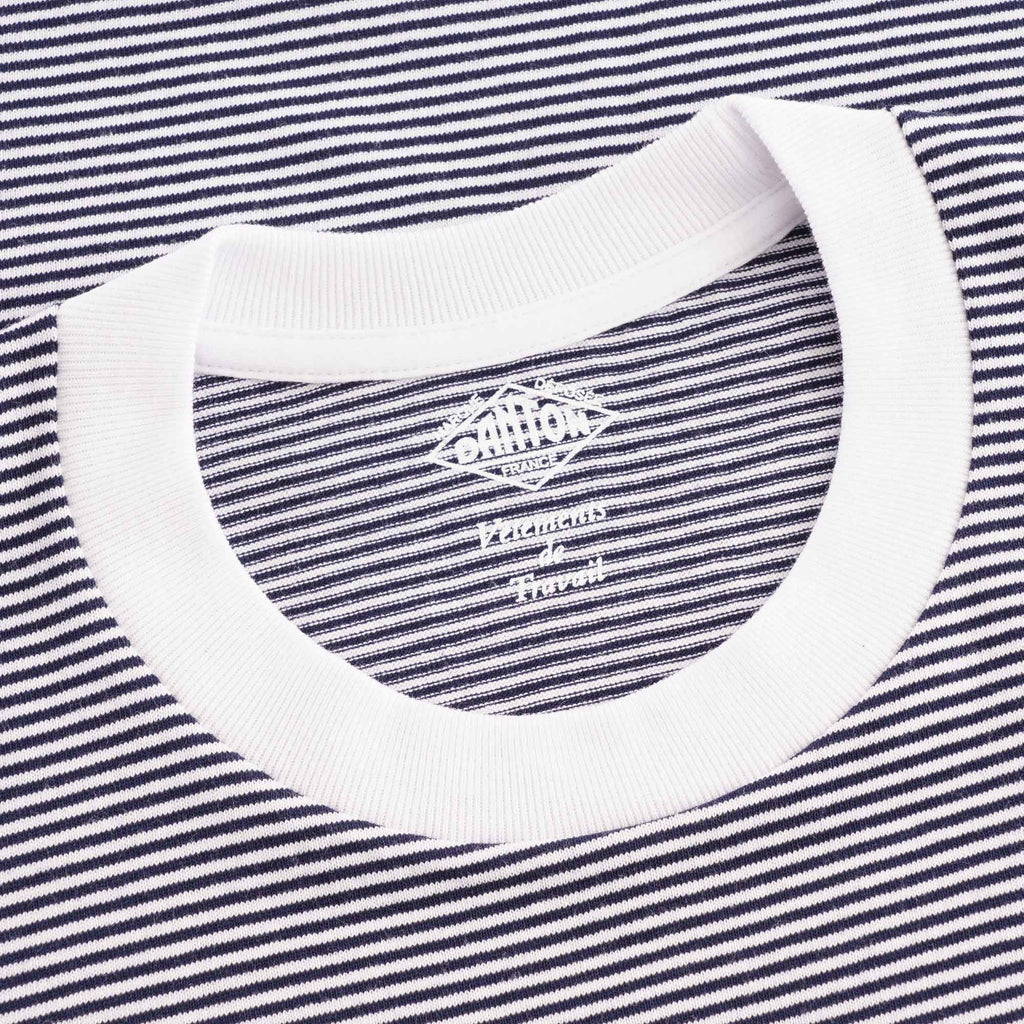 Close-up of the T-shirt's collar, showing a white band and striped fabric with a visible label.