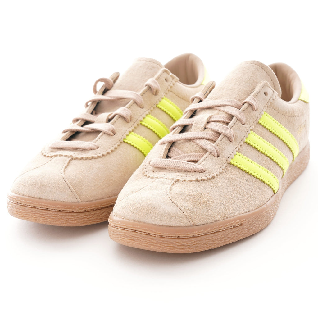 Pair of Adidas Campus 80s trainers in beige suede with bright yellow stripes.