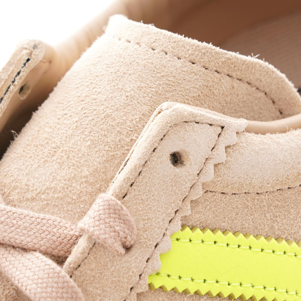 Detailed view of the laces and perforated side stripes on an Adidas Campus 80s trainer.