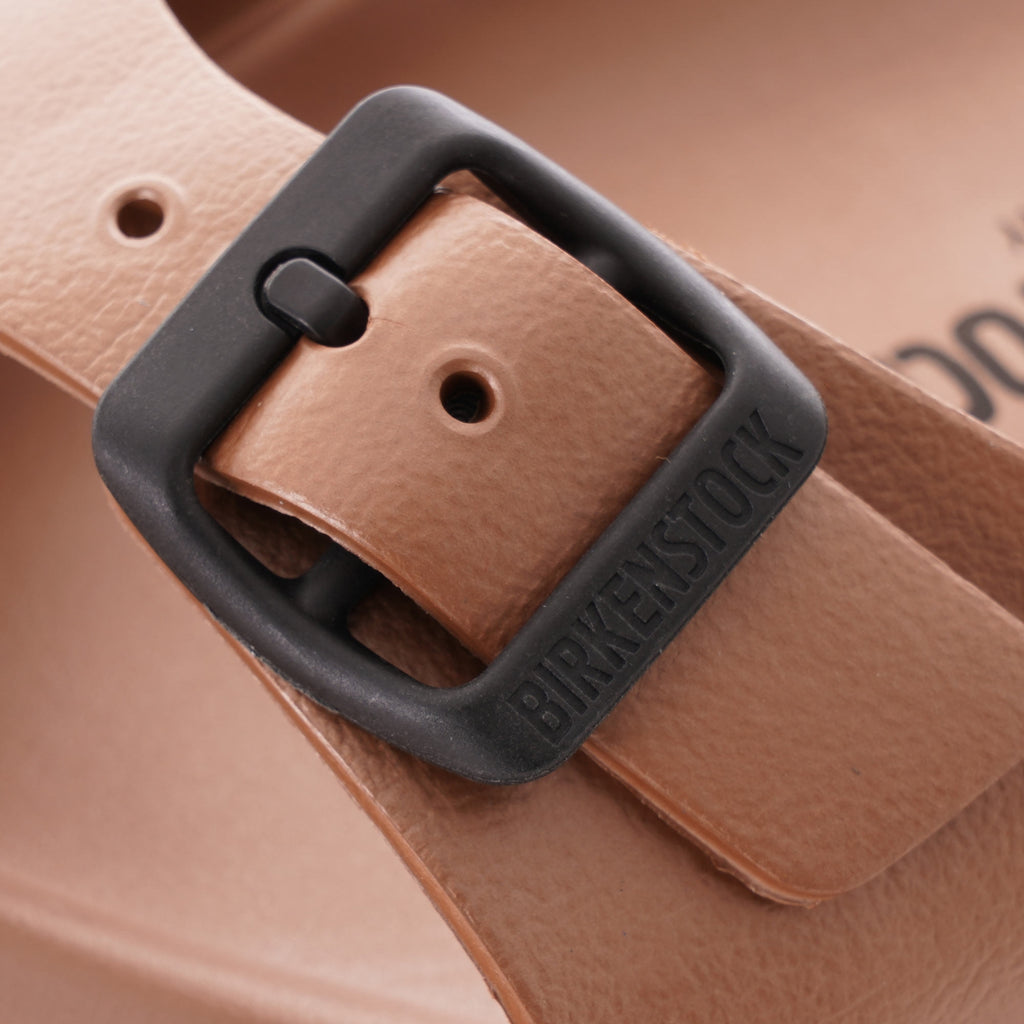 Close-up of the black buckle on a brown Birkenstock Honolulu EVA sandal.