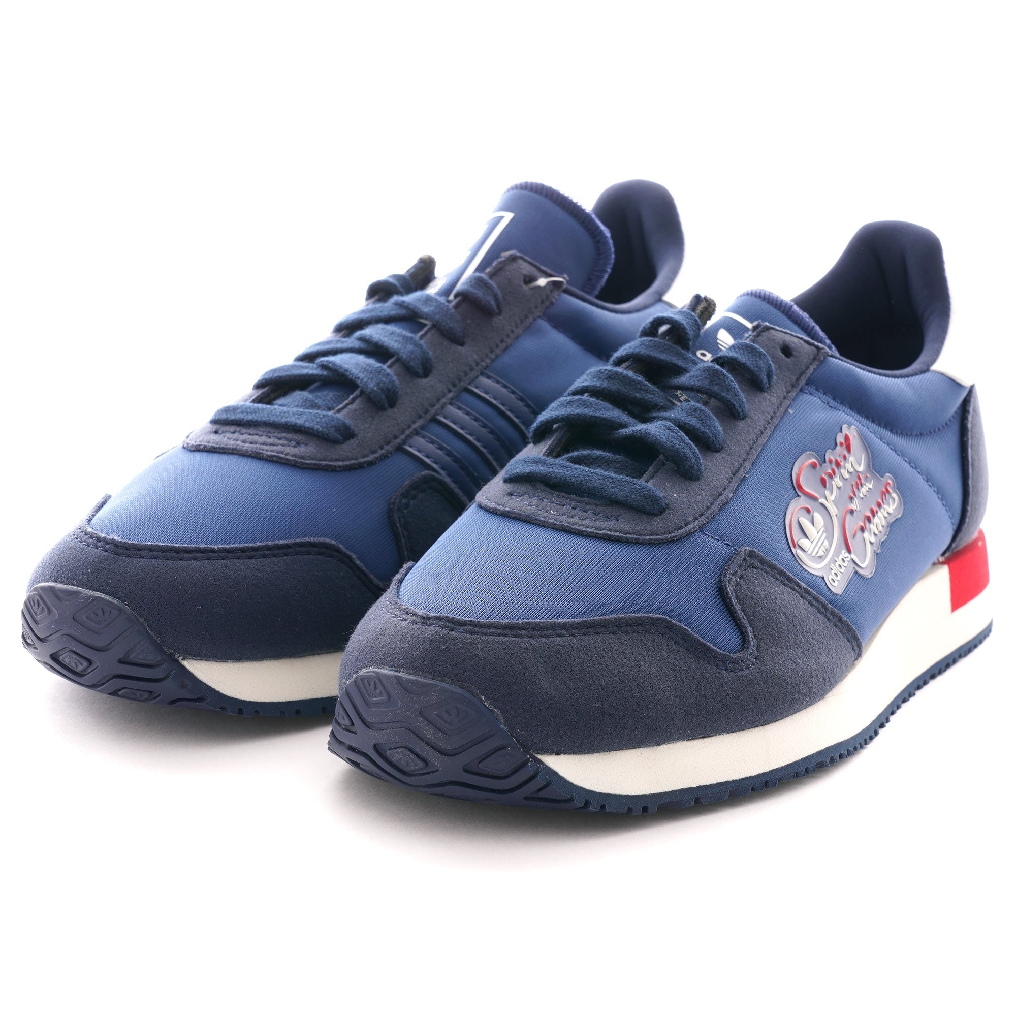 A pair of navy blue Adidas TRX Soulround shoes, angled to show both sneakers.