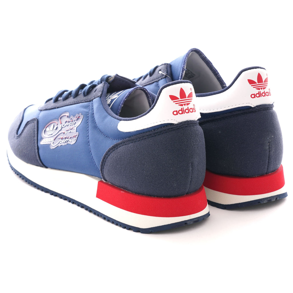 A rear-angle view of two navy blue Adidas TRX Soulround sneakers on a white background.
