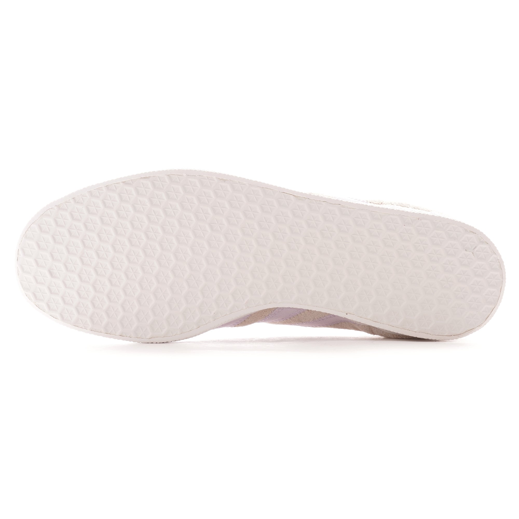 The textured white sole of a pale beige Adidas Gazelle trainer.