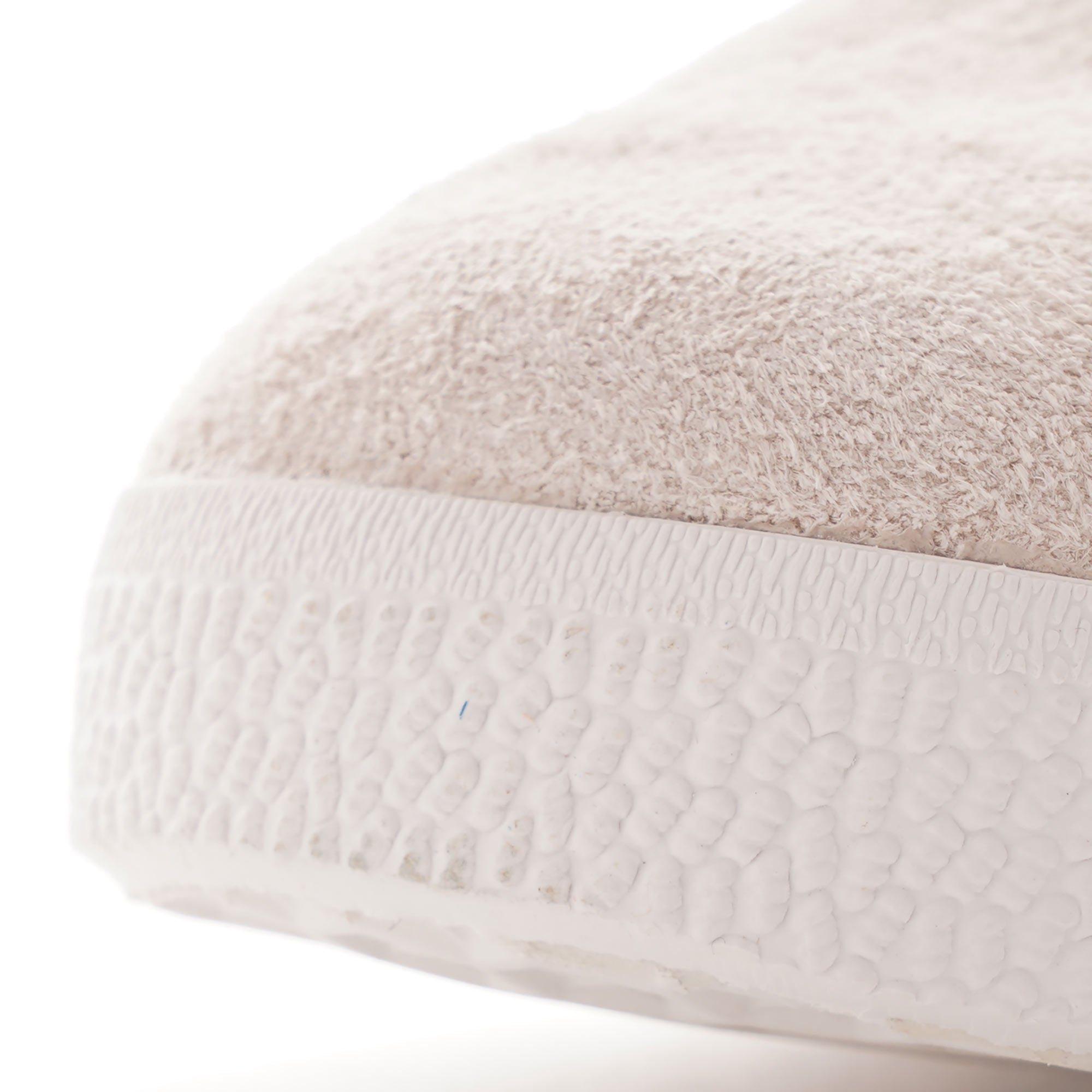 Close-up of the toe of a pale beige Adidas Gazelle trainer.