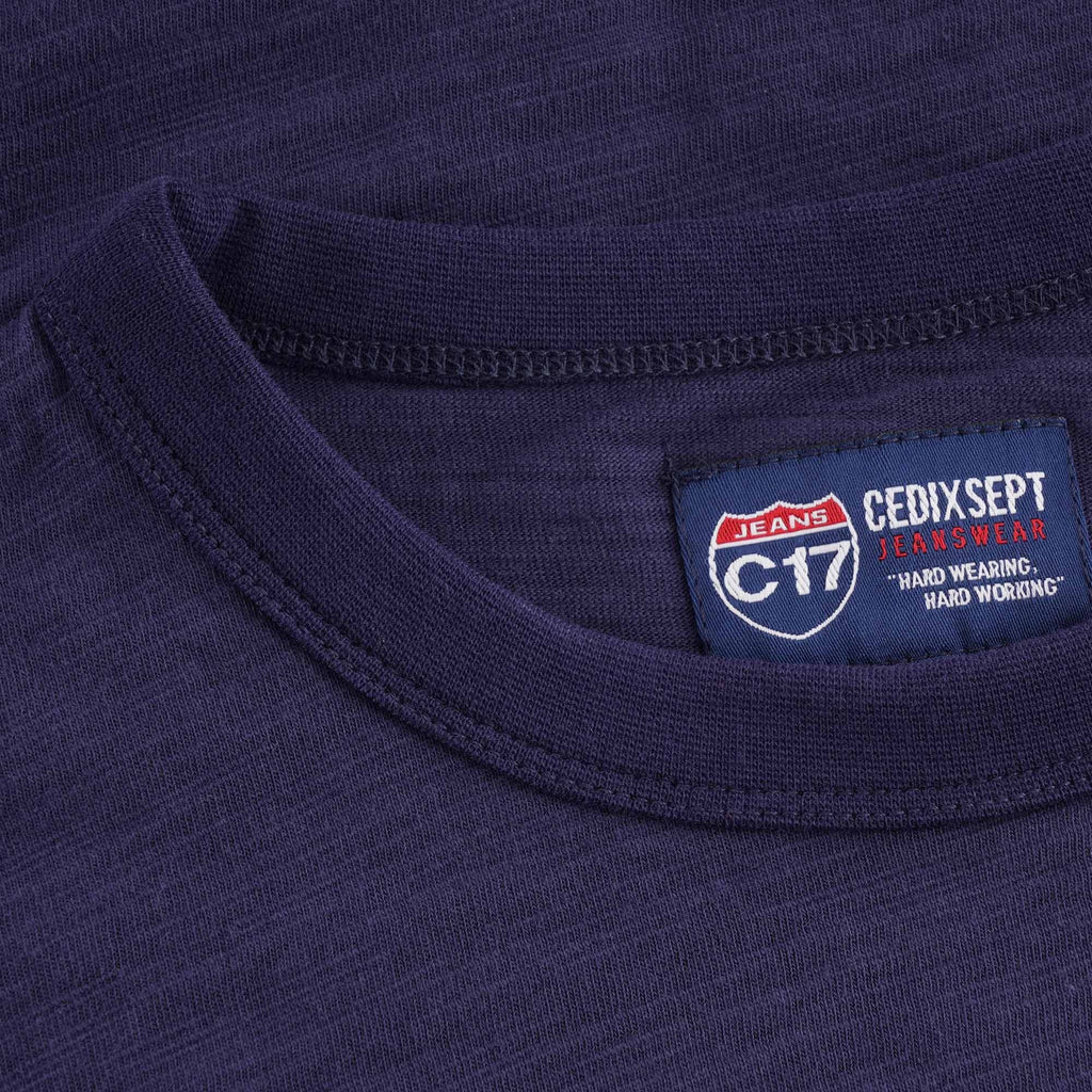 Detailed view of the C17 Jeans Cedixsept brand label at the collar of the t-shirt.
