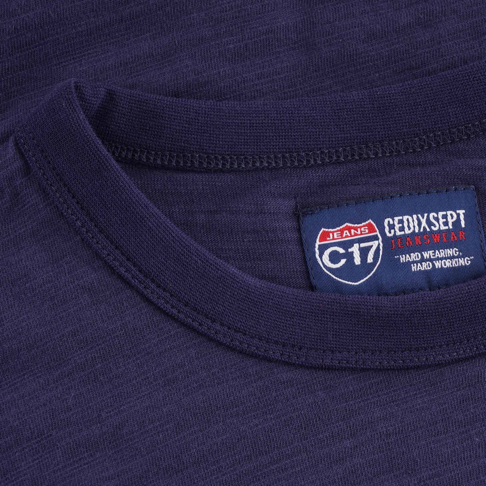Detailed view of the C17 Jeans Cedixsept brand label at the collar of the t-shirt.