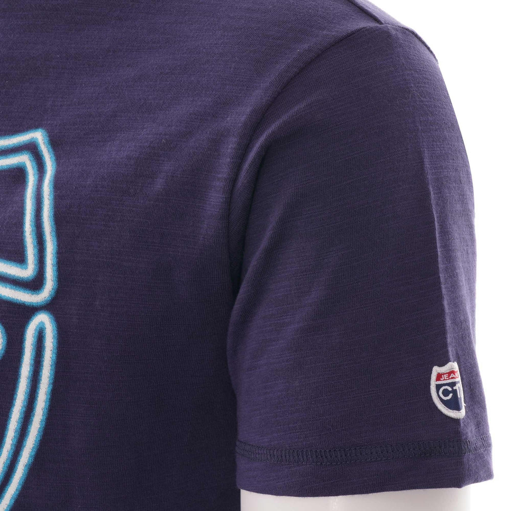 The C17 Jeans brand patch on the sleeve of the navy short sleeve t-shirt.