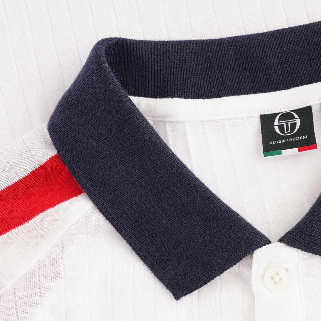 A close-up of the polo shirt's navy collar and a small brand tag with Italian flag colours.