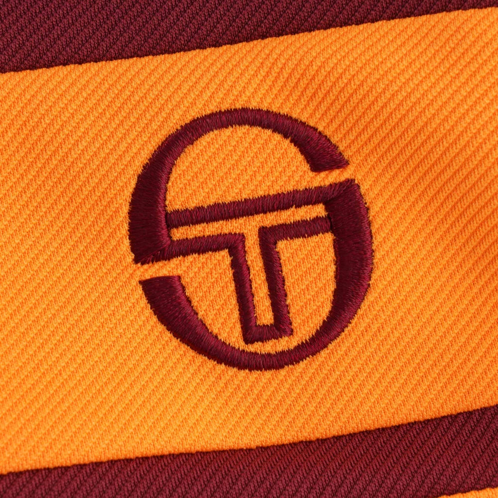 A close-up of the embroidered Sergio Tacchini logo on the track top.