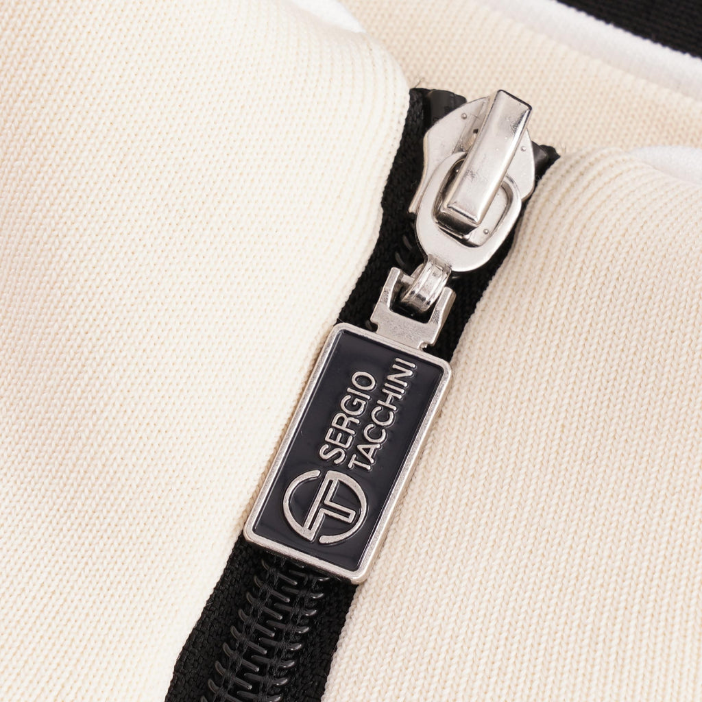 A close-up of the zipper pull with the Sergio Tacchini logo.