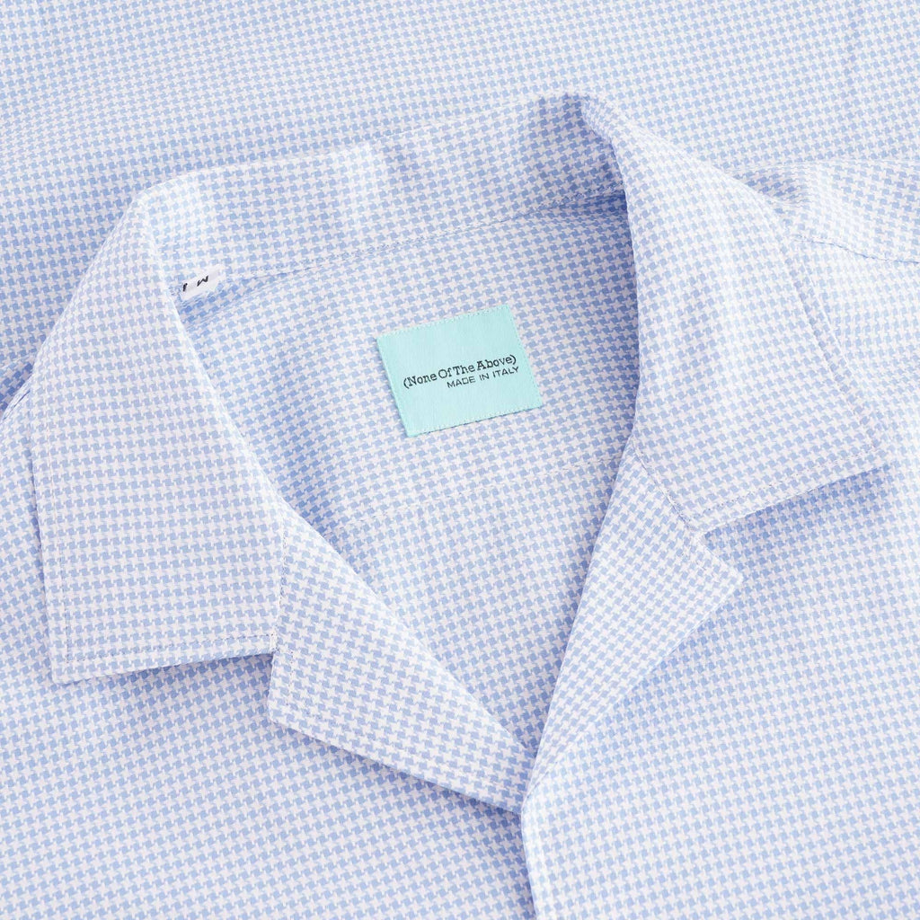 Close-up of the light blue houndstooth shirt's revere collar and neck label.