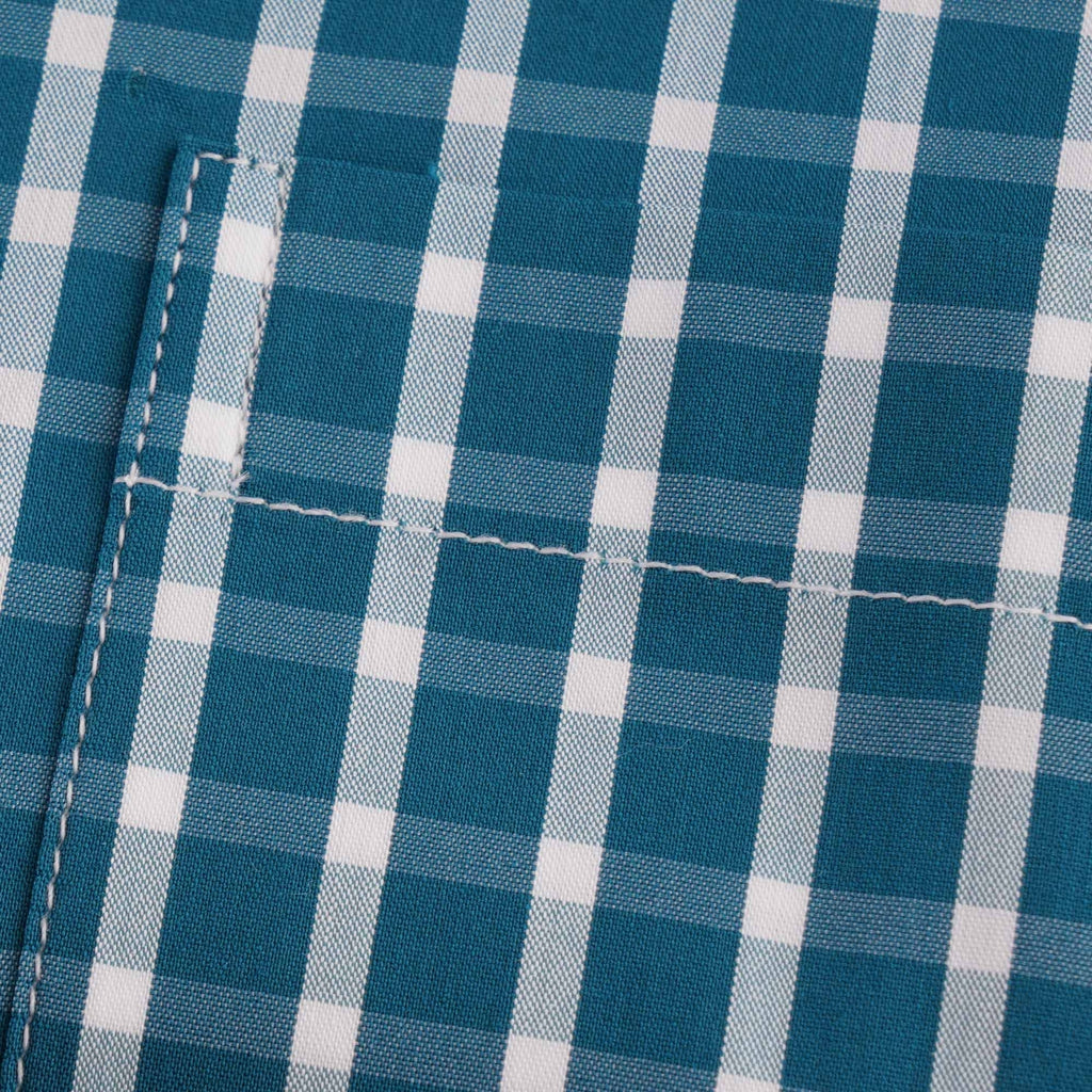 Close-up of the shirt pocket, highlighting the checked fabric and stitching.