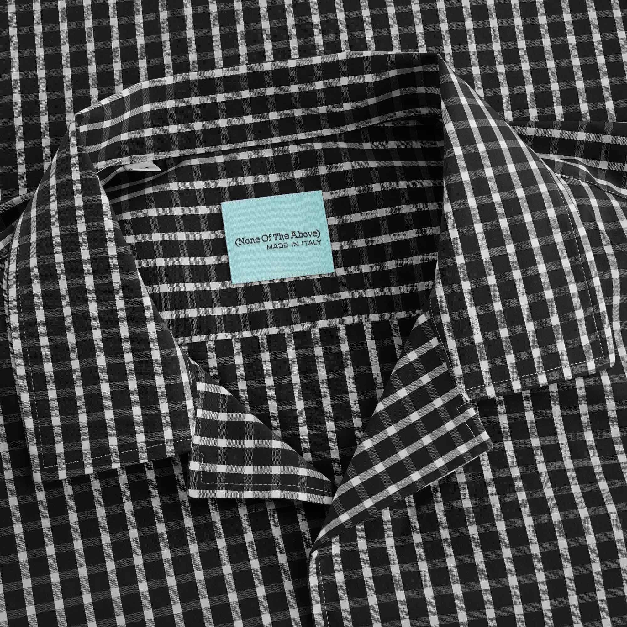 A close-up of the shirt's collar, showing the blue brand label on the neck.