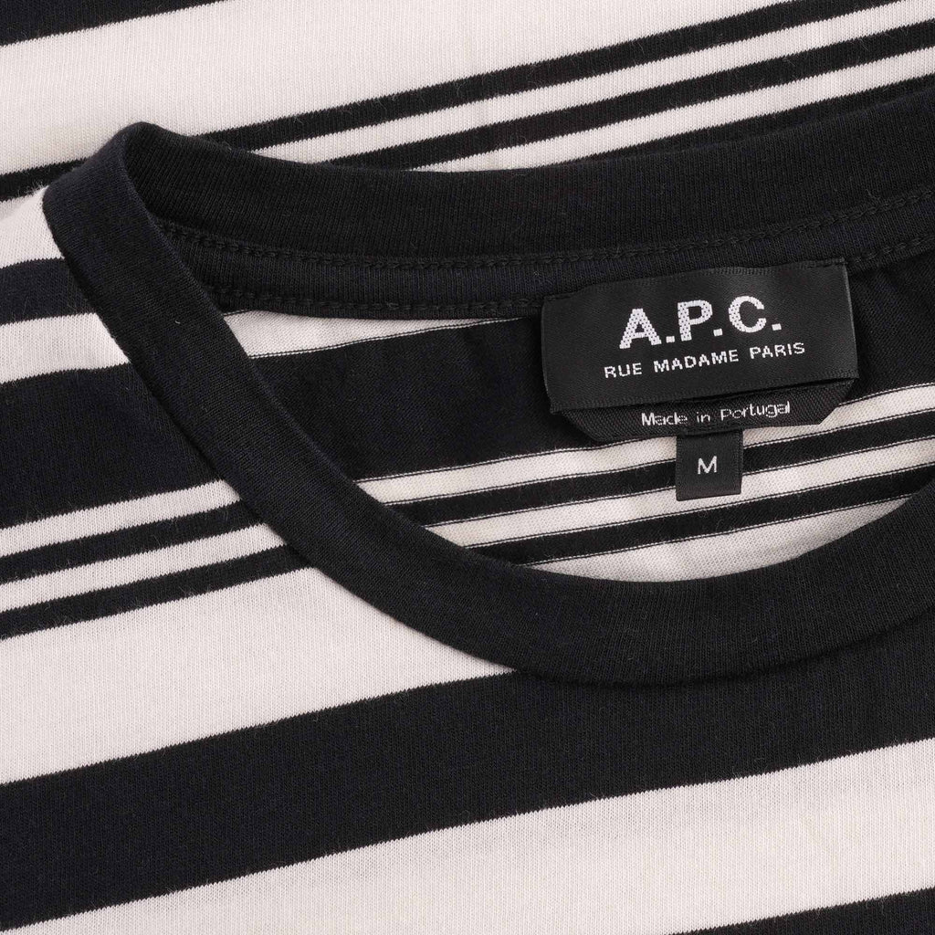 A close-up of the T-shirt's neckline and brand label, showing 'A.P.C.' and 'RUE MADAME PARIS'.