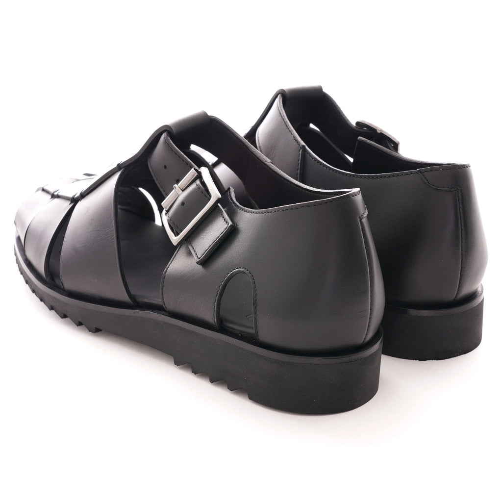 A rear view of two black leather fisherman sandals, showcasing the heel and buckle.