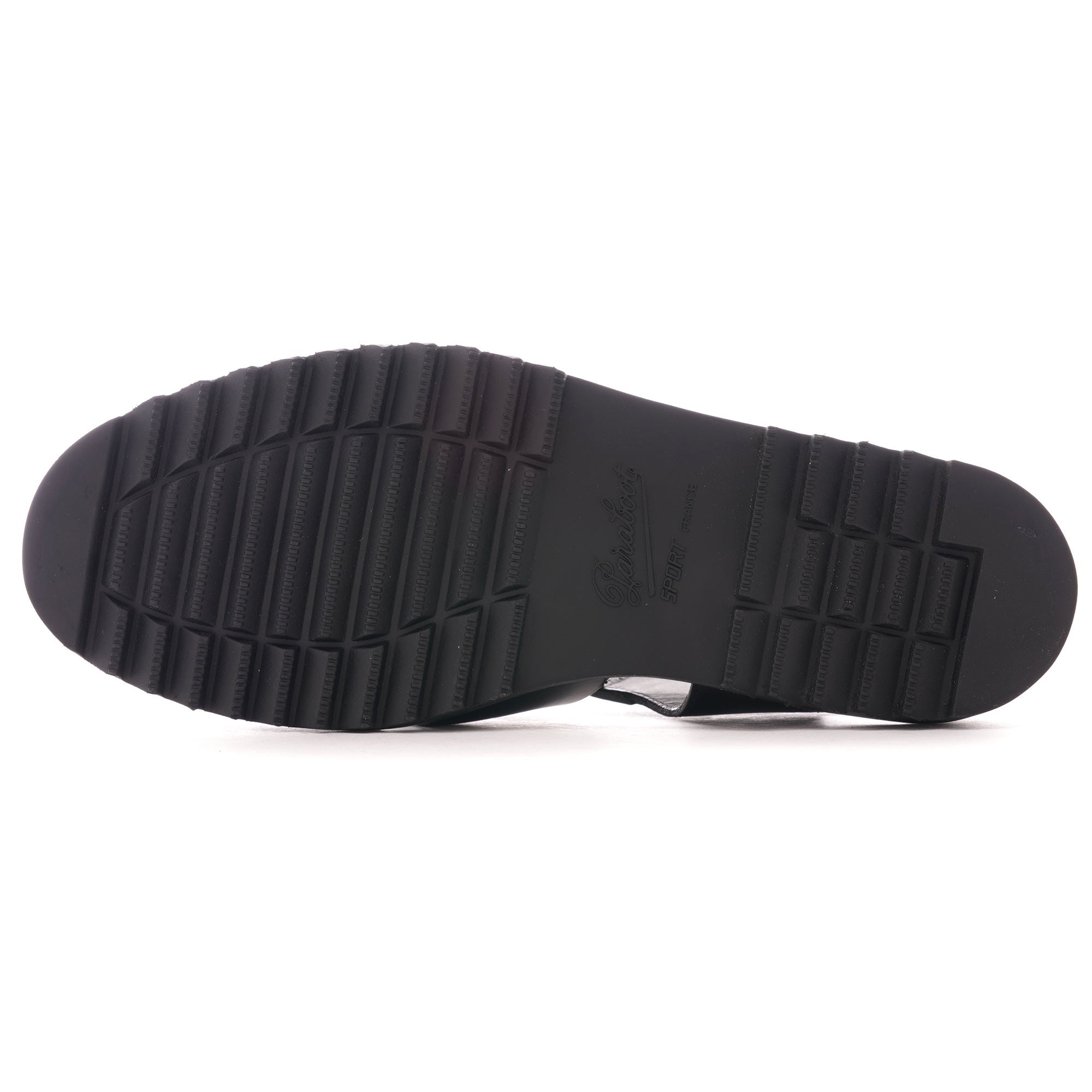 The textured, ridged black sole of a fisherman sandal.