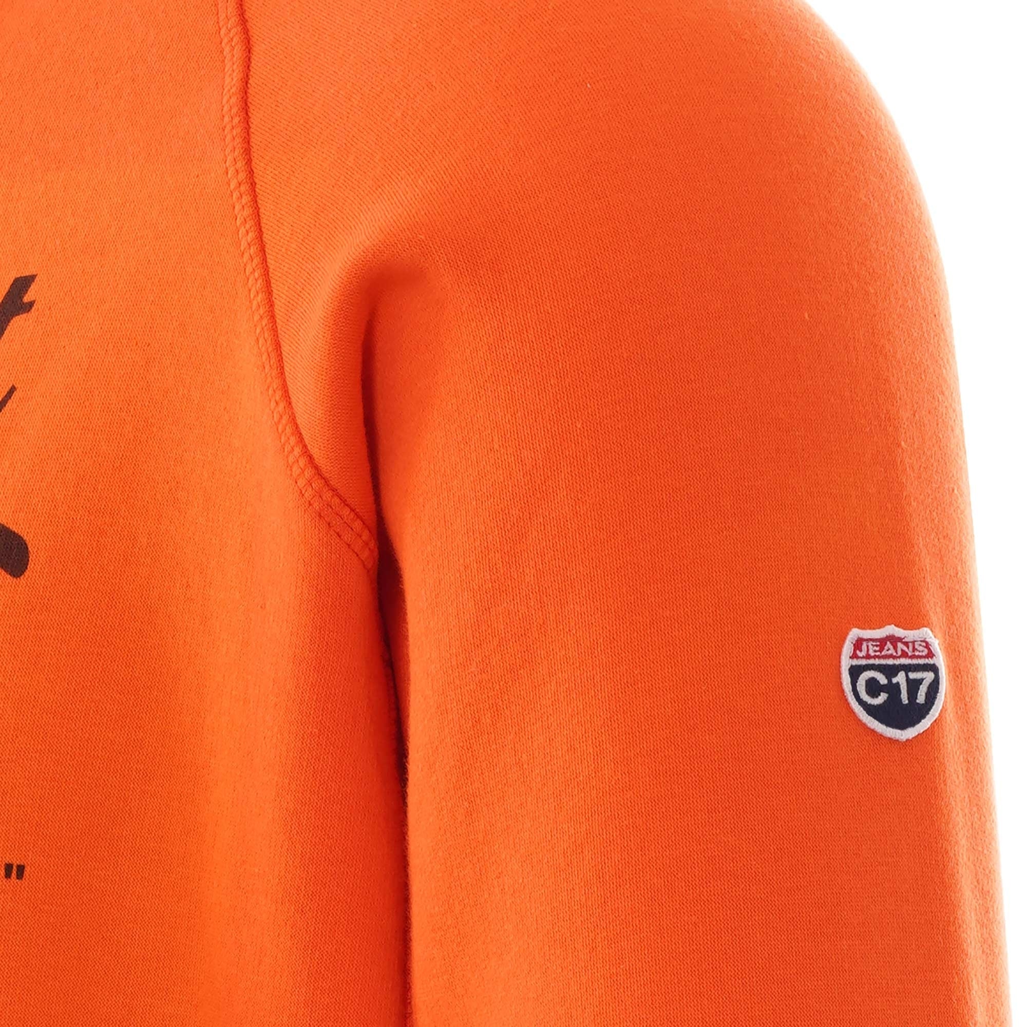 Sleeve of the orange hoodie showing a C17 logo patch.