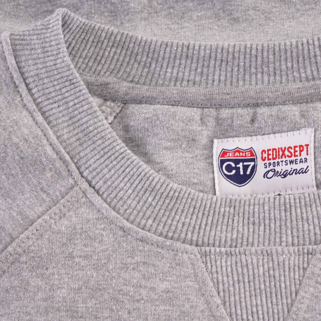 Close-up of the grey sweatshirt collar showing the brand tag.