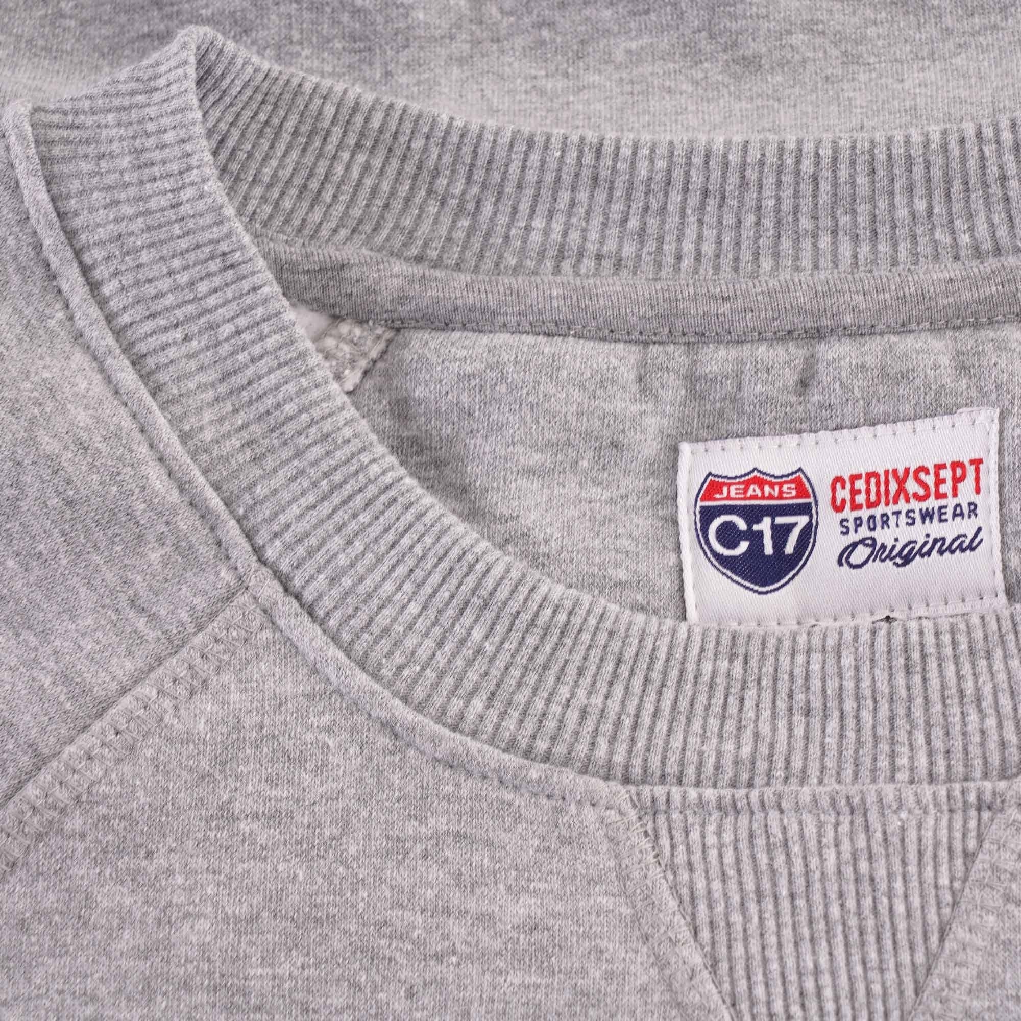 Close-up of the grey sweatshirt collar showing the brand tag.