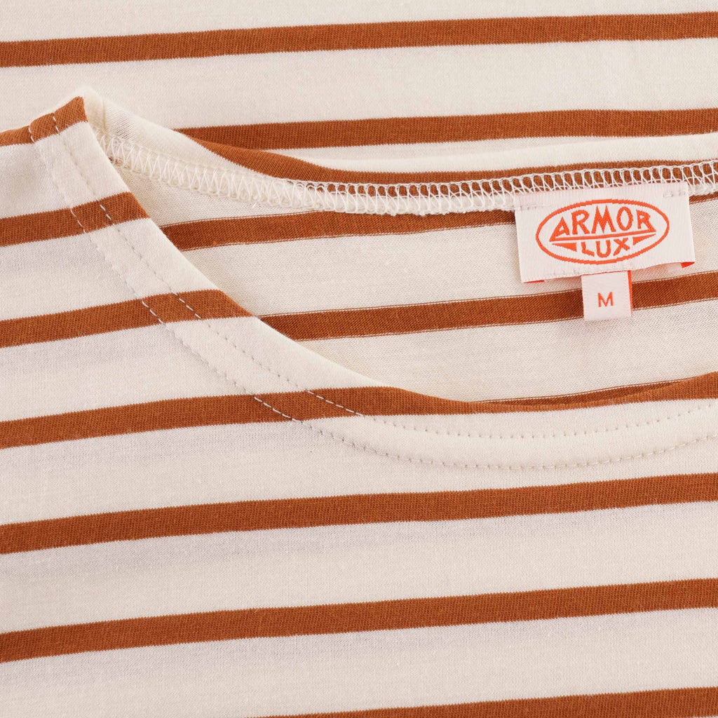 Close-up of the inner neck label of an Armor Lux striped t-shirt.