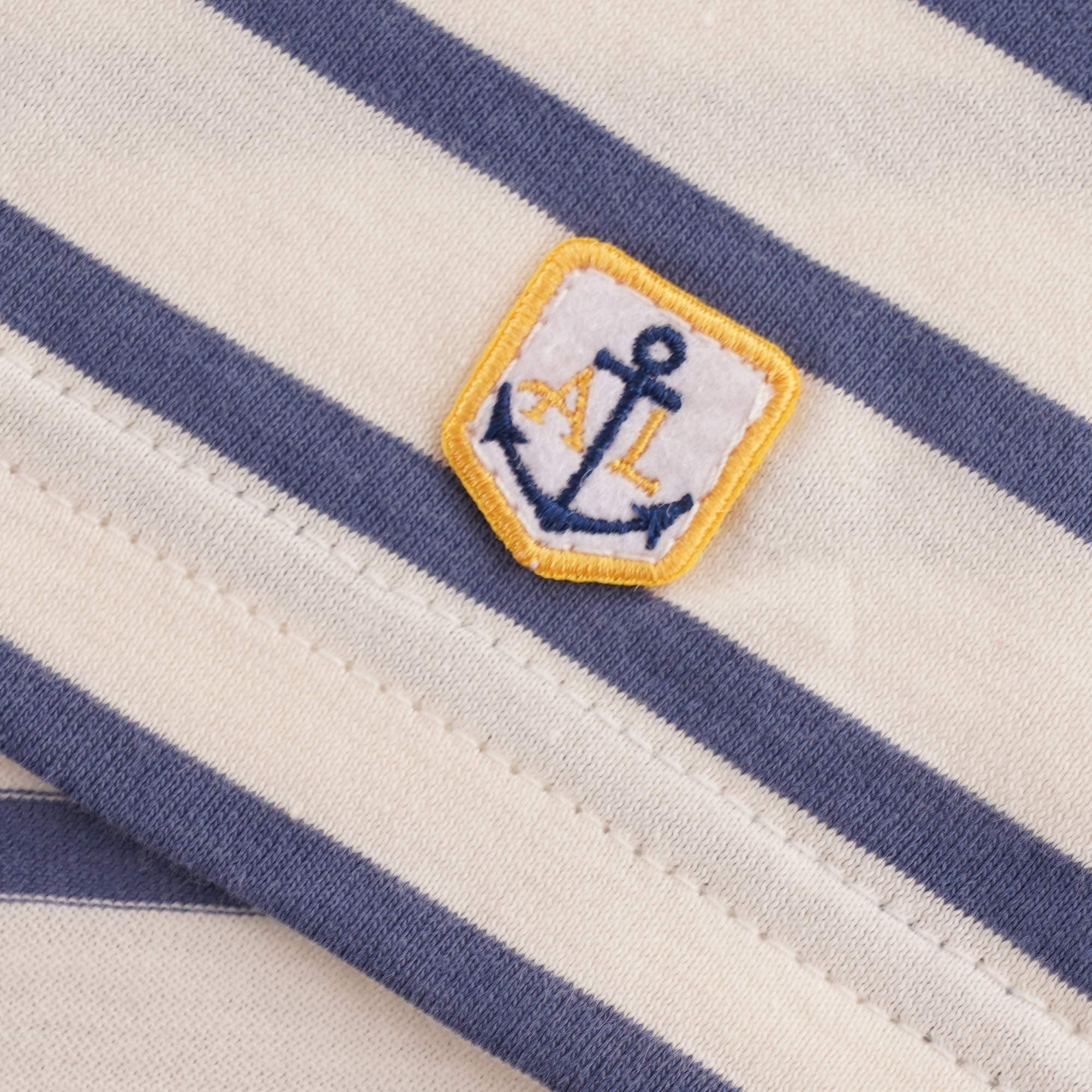 A close up of the t-shirt's anchor emblem.