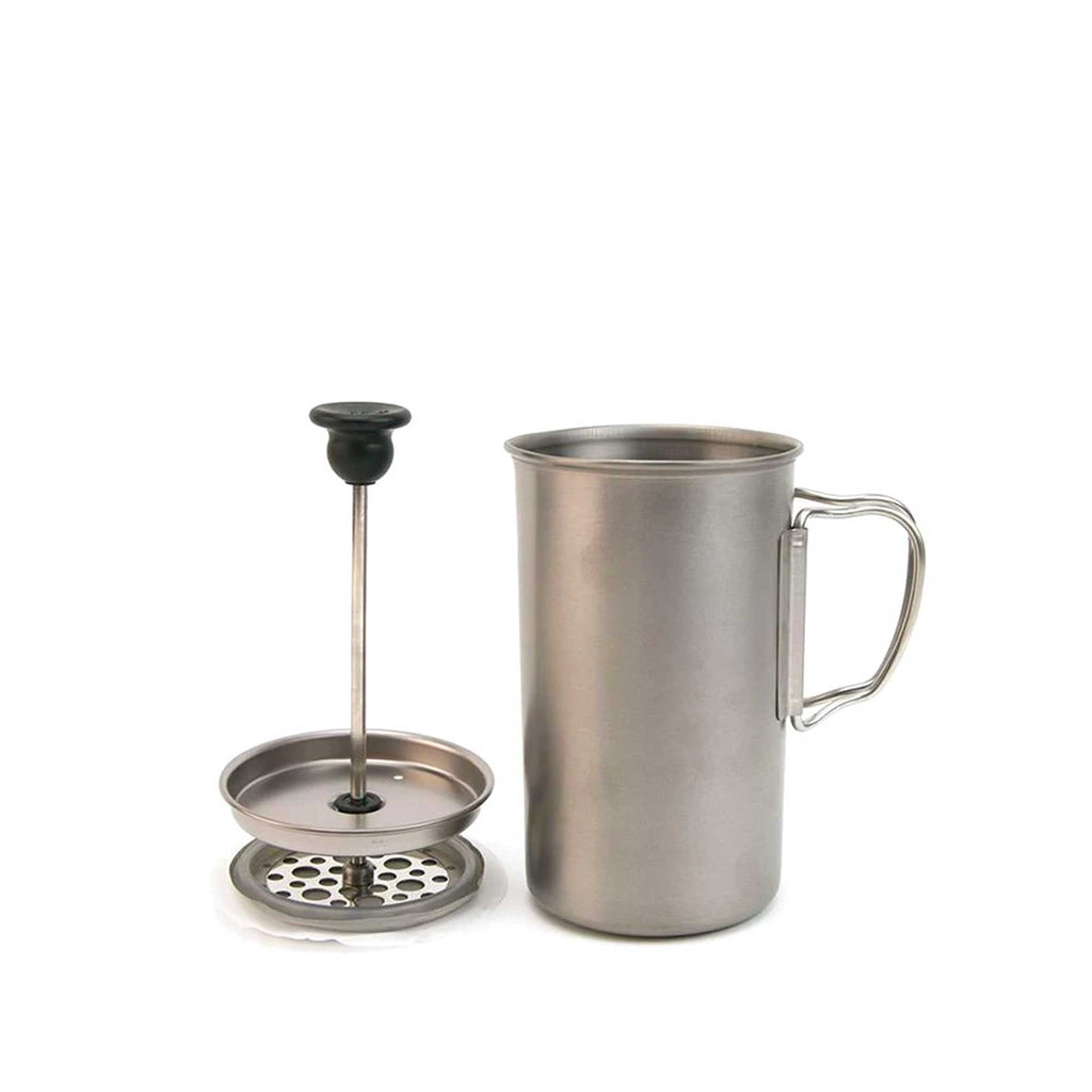 The stainless steel coffee press and its plunger mechanism are separated on a white surface.