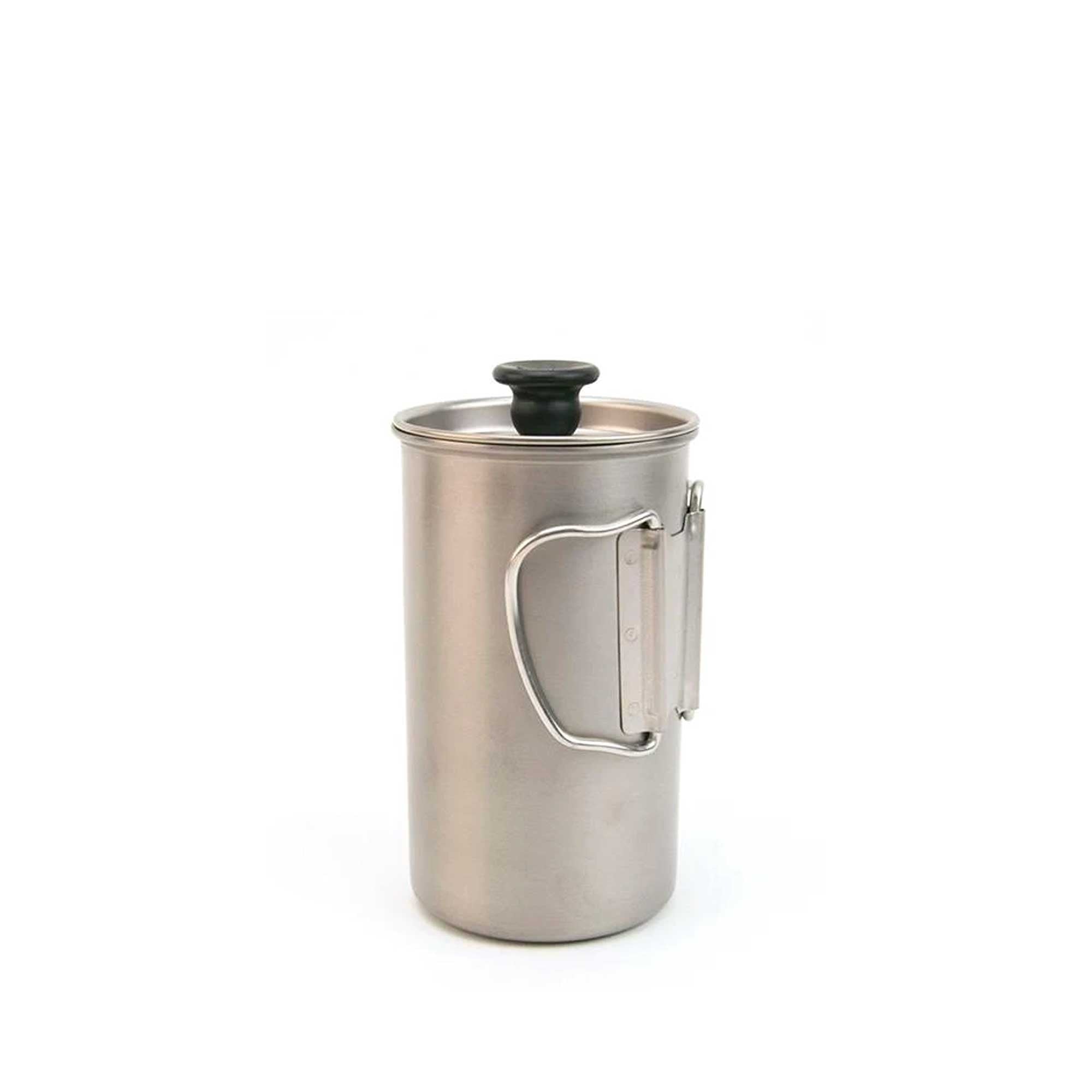 A stainless steel travel coffee press is shown with its handle folded for compact storage.