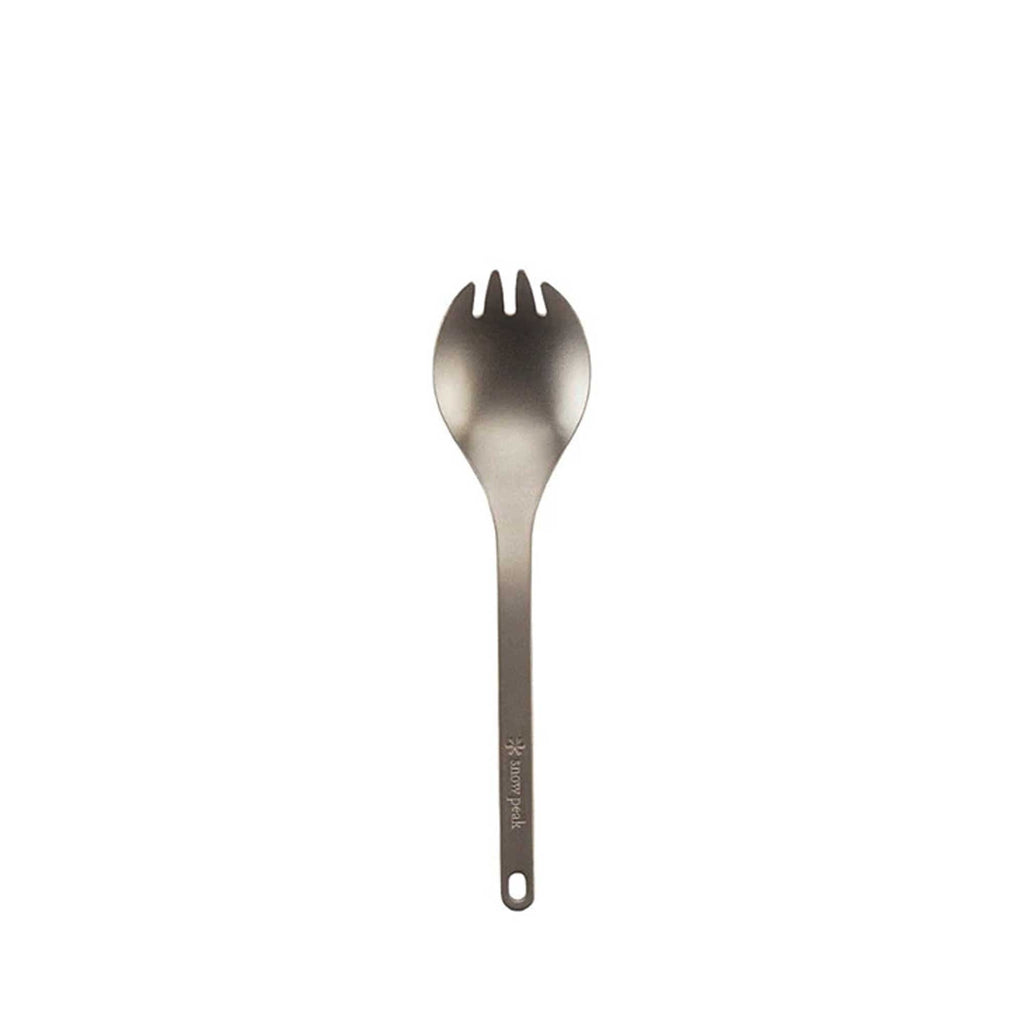 A close-up of a titanium spork on a white background, highlighting its versatile design.