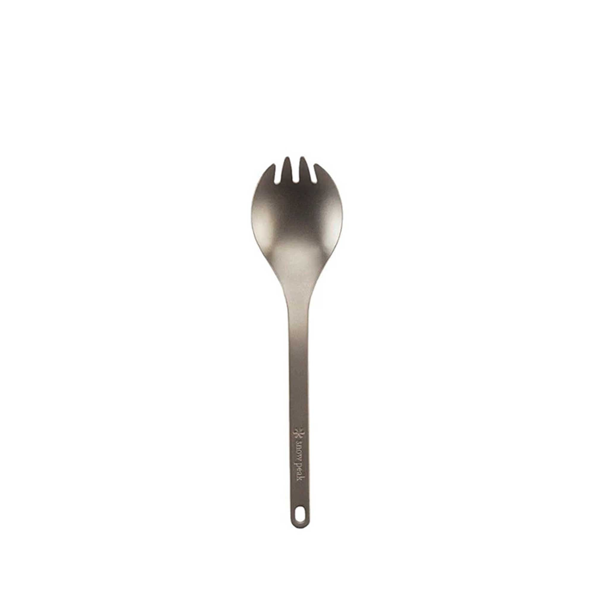 A close-up of a titanium spork on a white background, highlighting its versatile design.