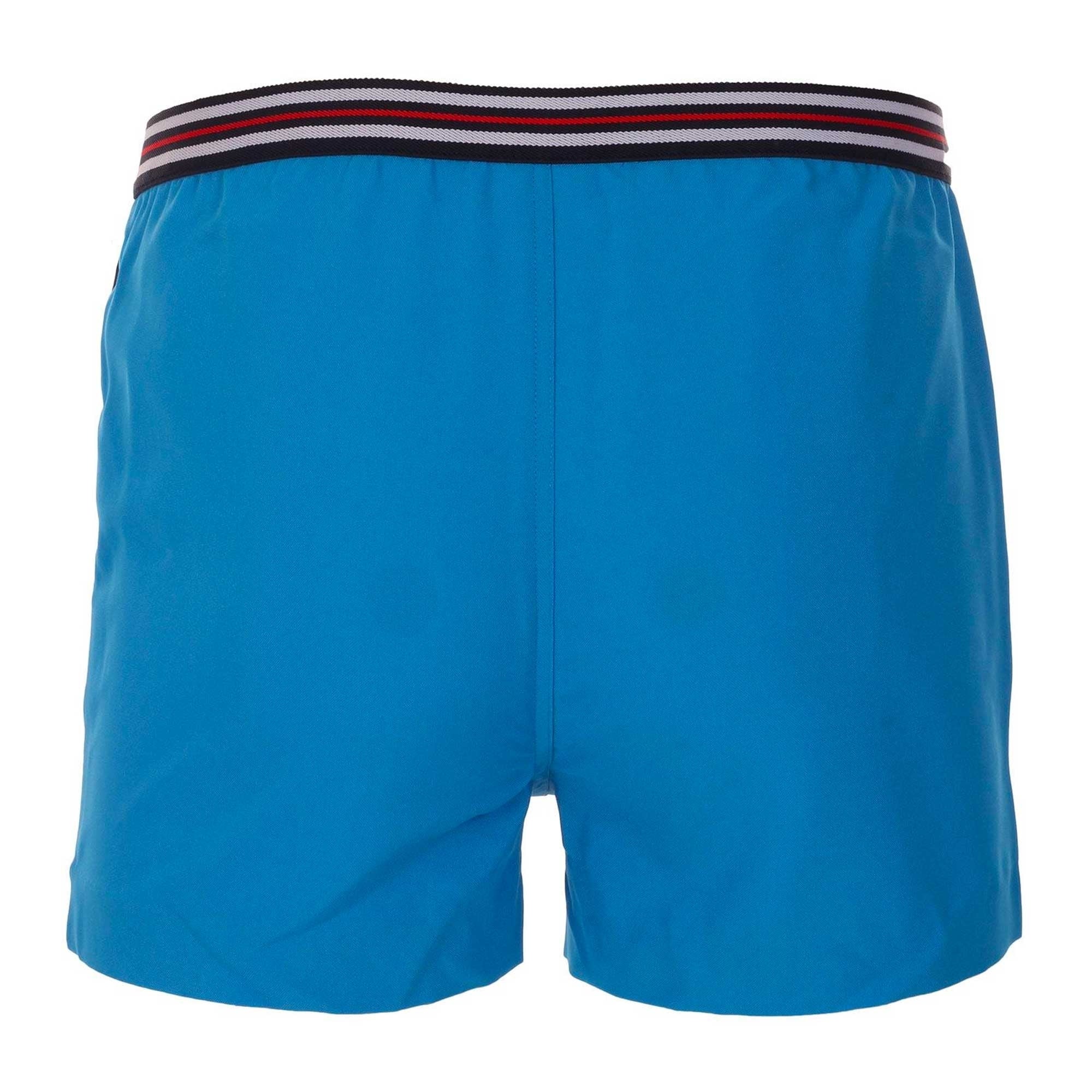 Back view of blue men's swim shorts with a striped waistband.