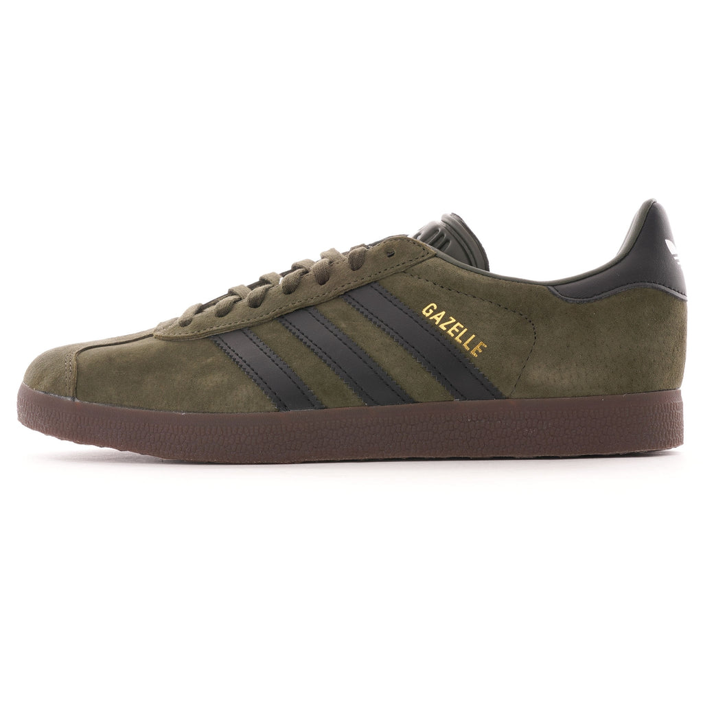 A single Adidas Gazelle trainer in olive green suede with black stripes and brown sole. 