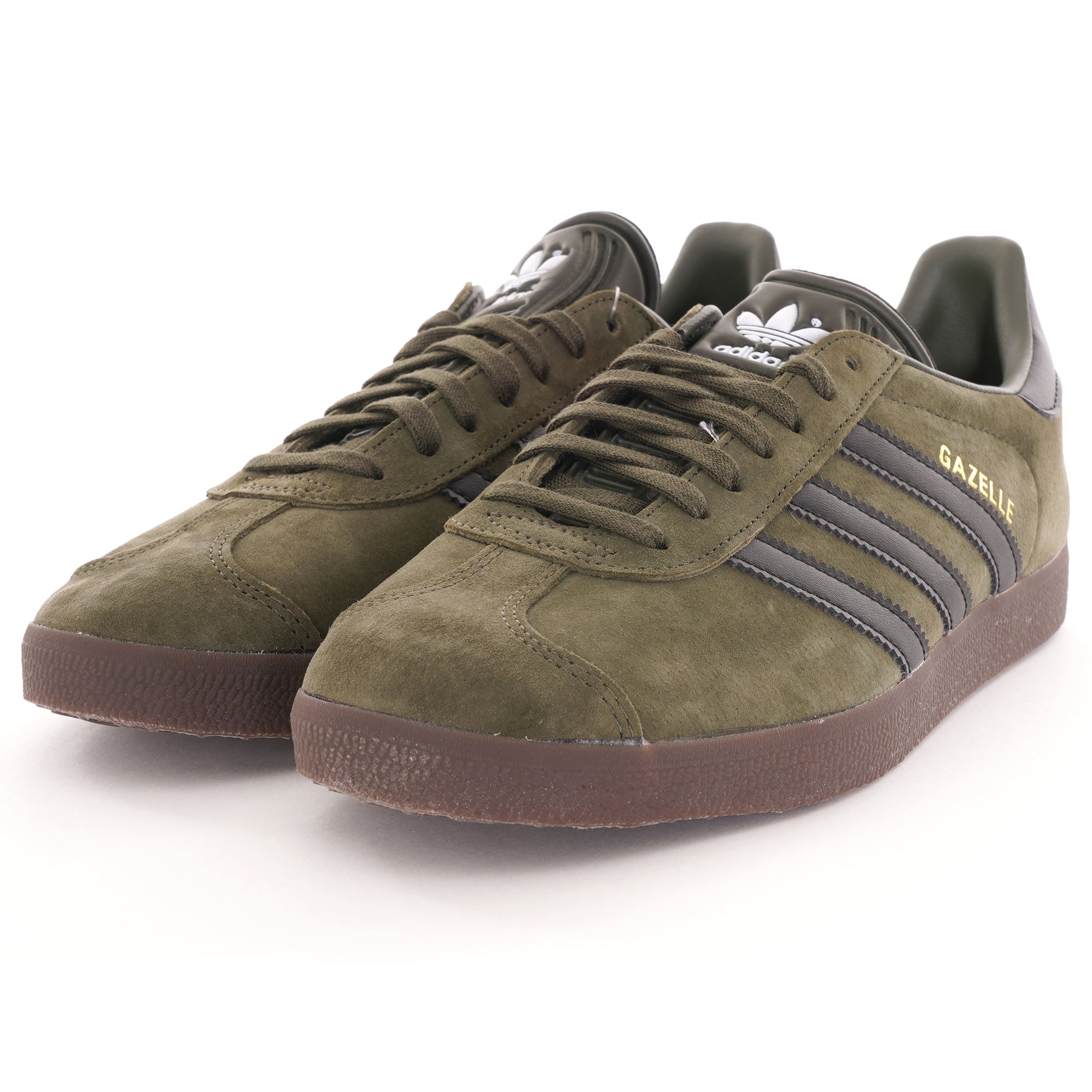 A pair of olive green suede Adidas Gazelle trainers with black stripes and brown soles. 