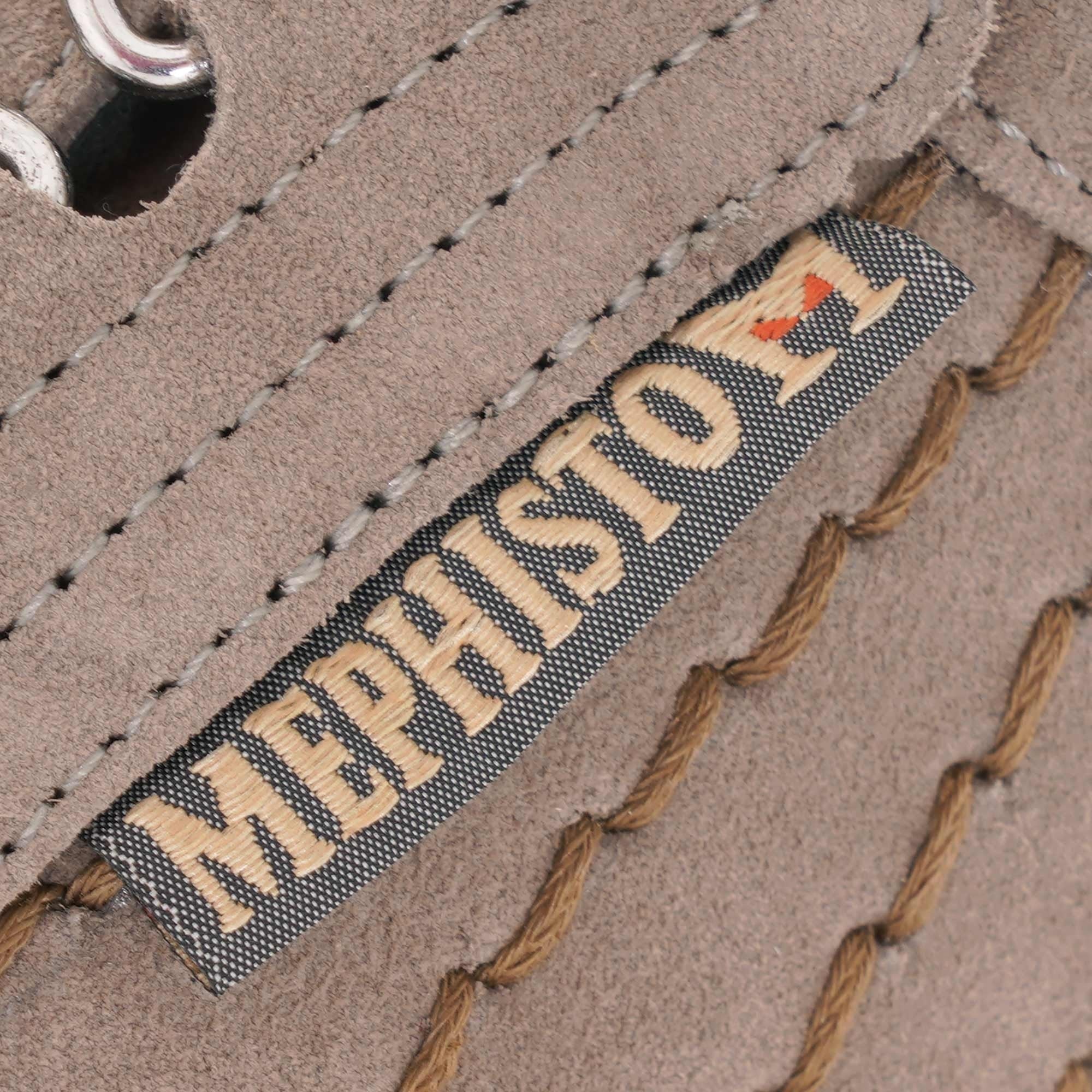 A close-up of the 'Mephisto' brand label stitched onto the side of a beige suede shoe.