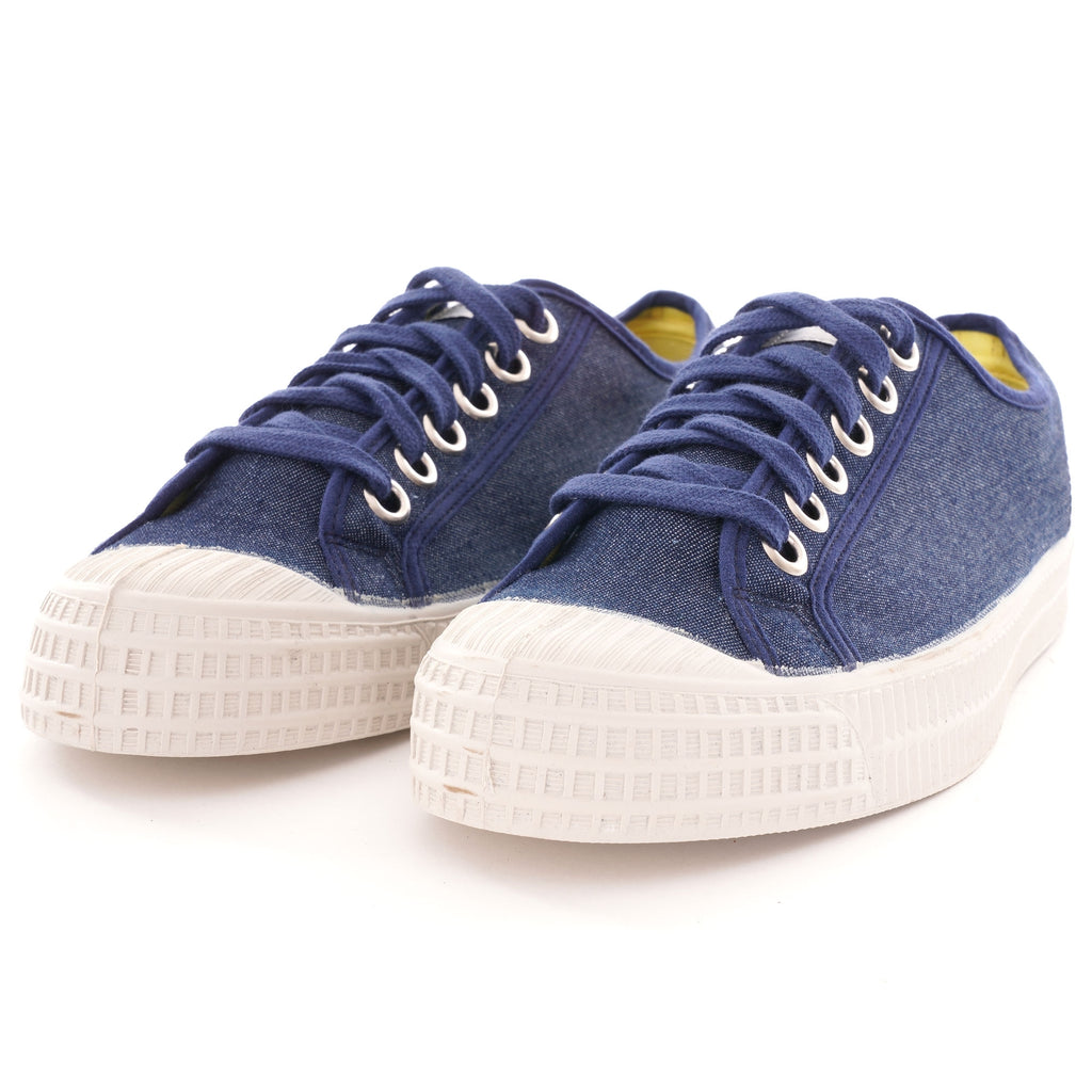 Pair of navy blue canvas shoes with white soles and laces, positioned slightly angled.