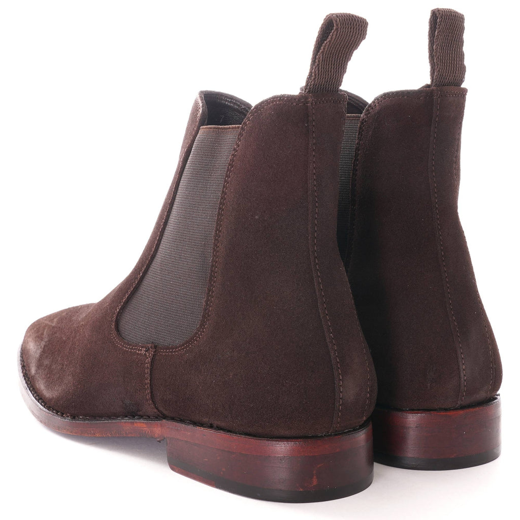 Rear view of a pair of brown suede Chelsea boots.