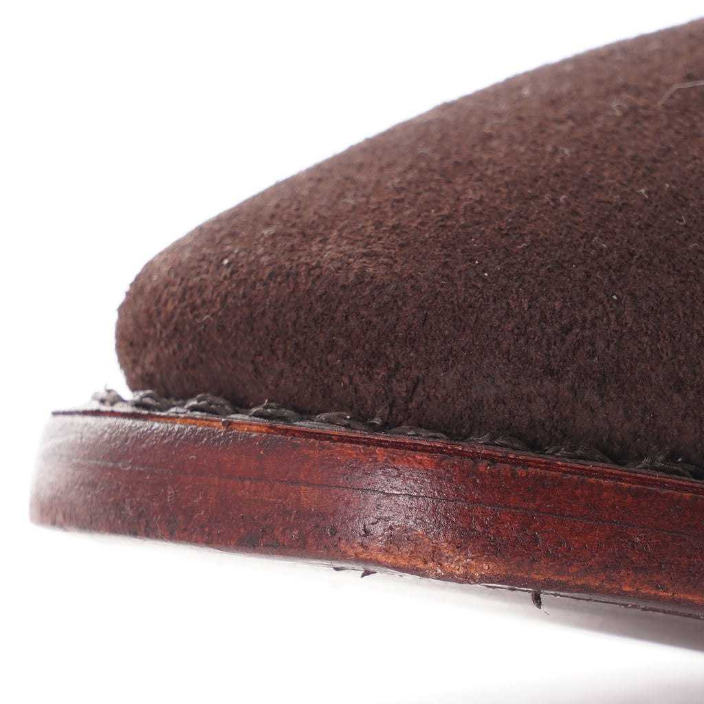 Close-up of the toe box and sole stitching of a brown suede Chelsea boot.