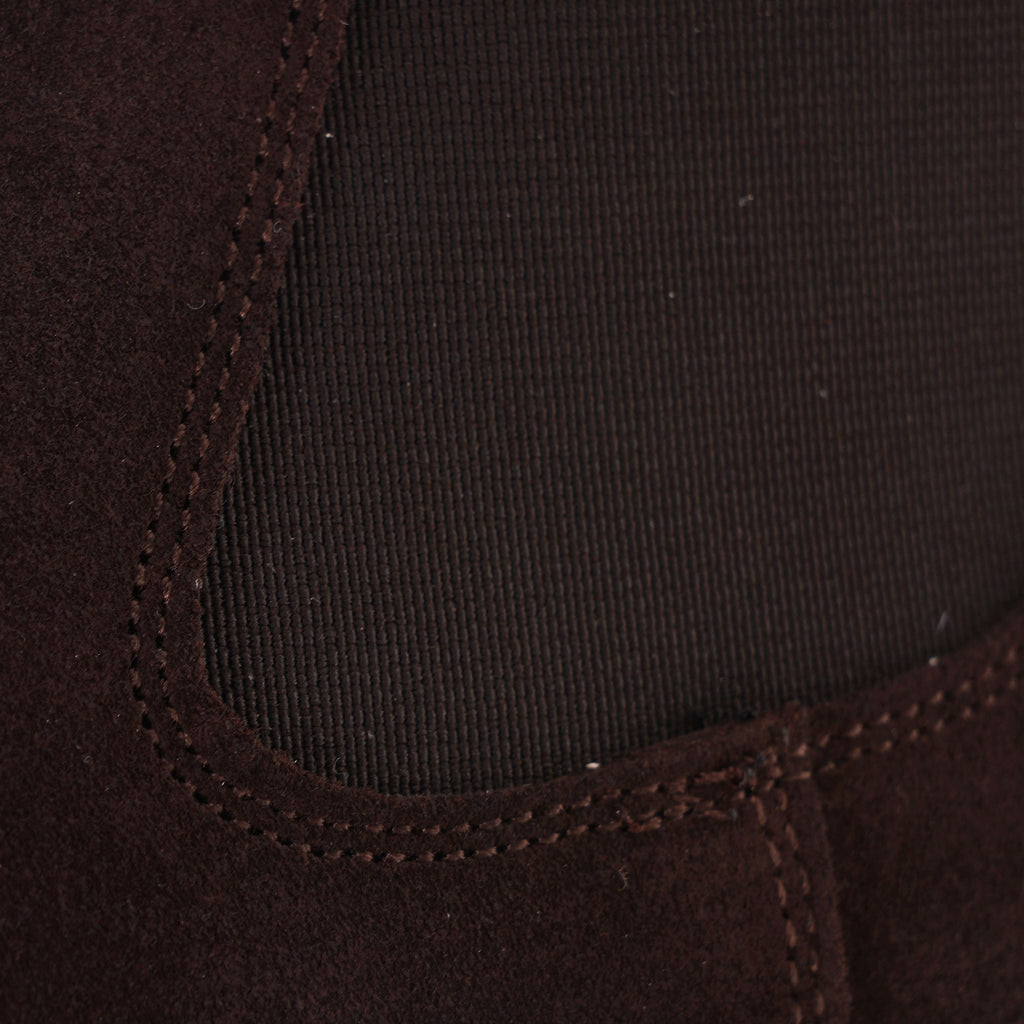 Close-up of the elasticated side panel on a brown suede Chelsea boot.