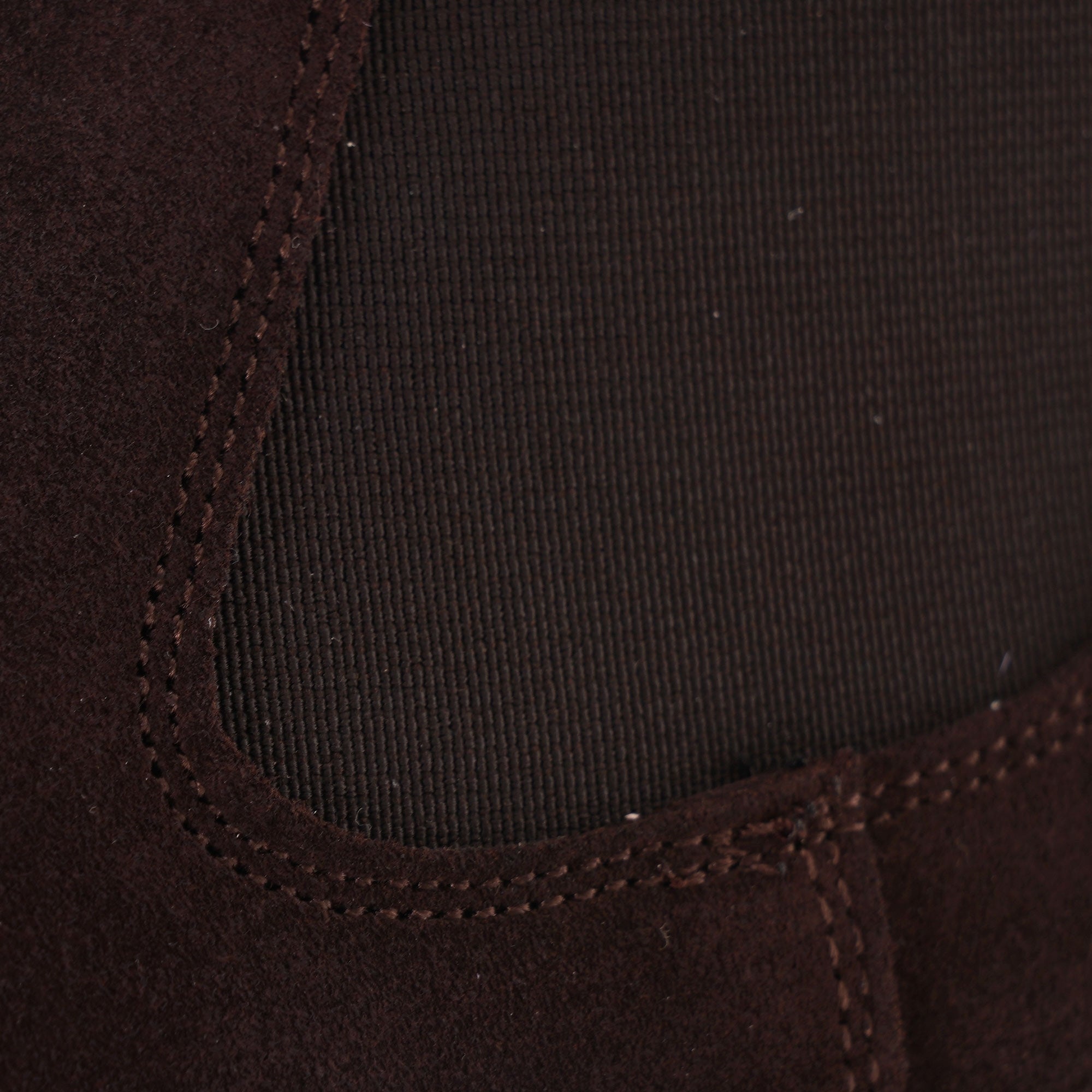 Close-up of the elasticated side panel on a brown suede Chelsea boot.
