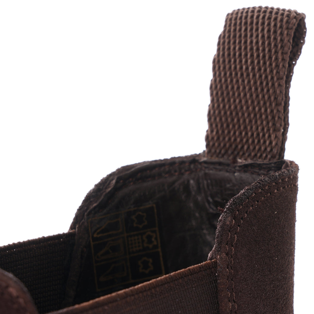 Close-up of the brown pull tab and interior lining of a Chelsea boot.