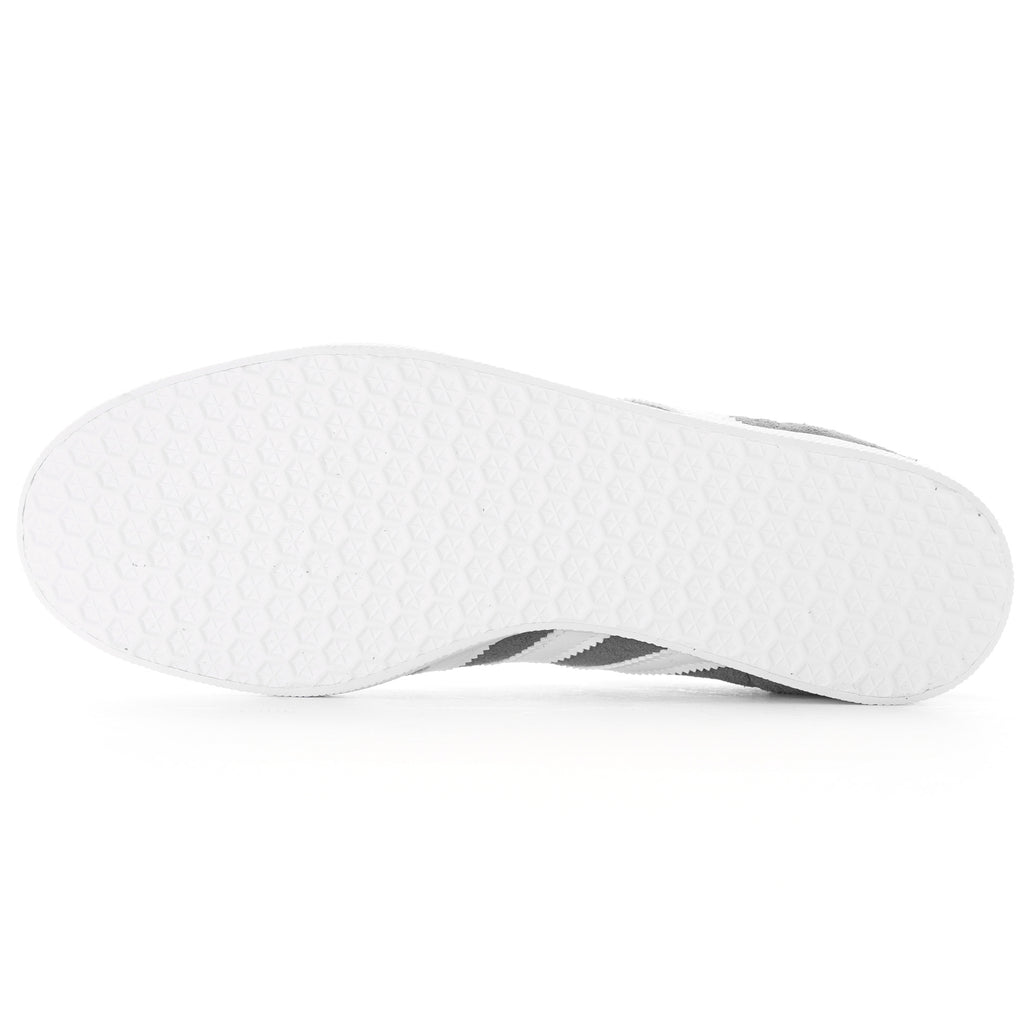 Bottom of a grey Adidas Gazelle trainer with a white textured sole.