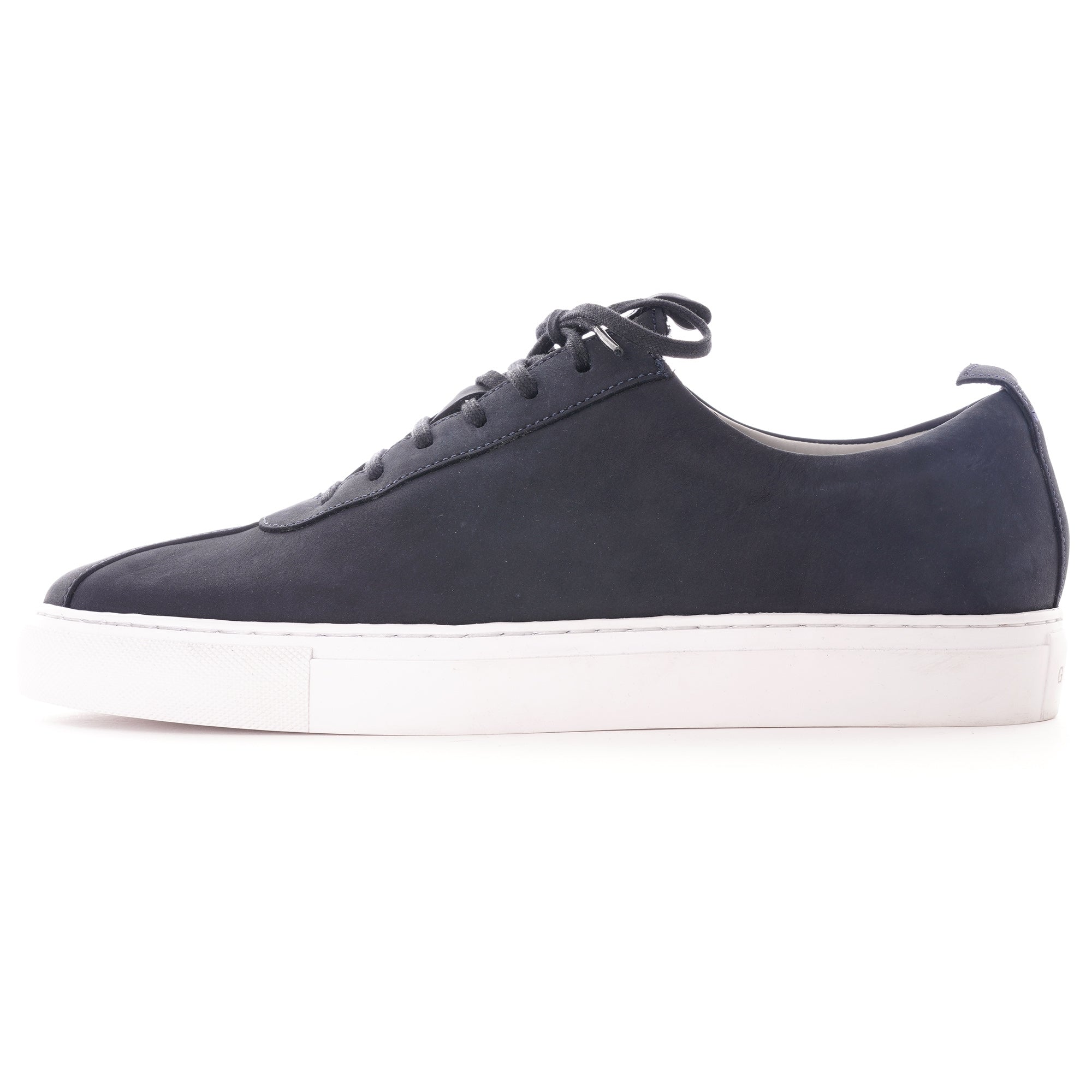 Side profile of a dark blue shoe with white soles. Perfect for casual wear.